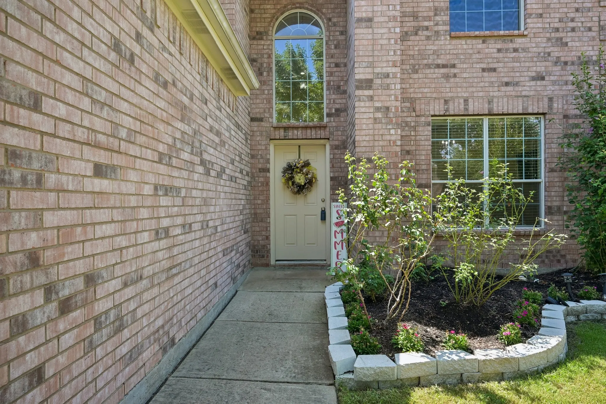 Brick exterior with an arched transom window