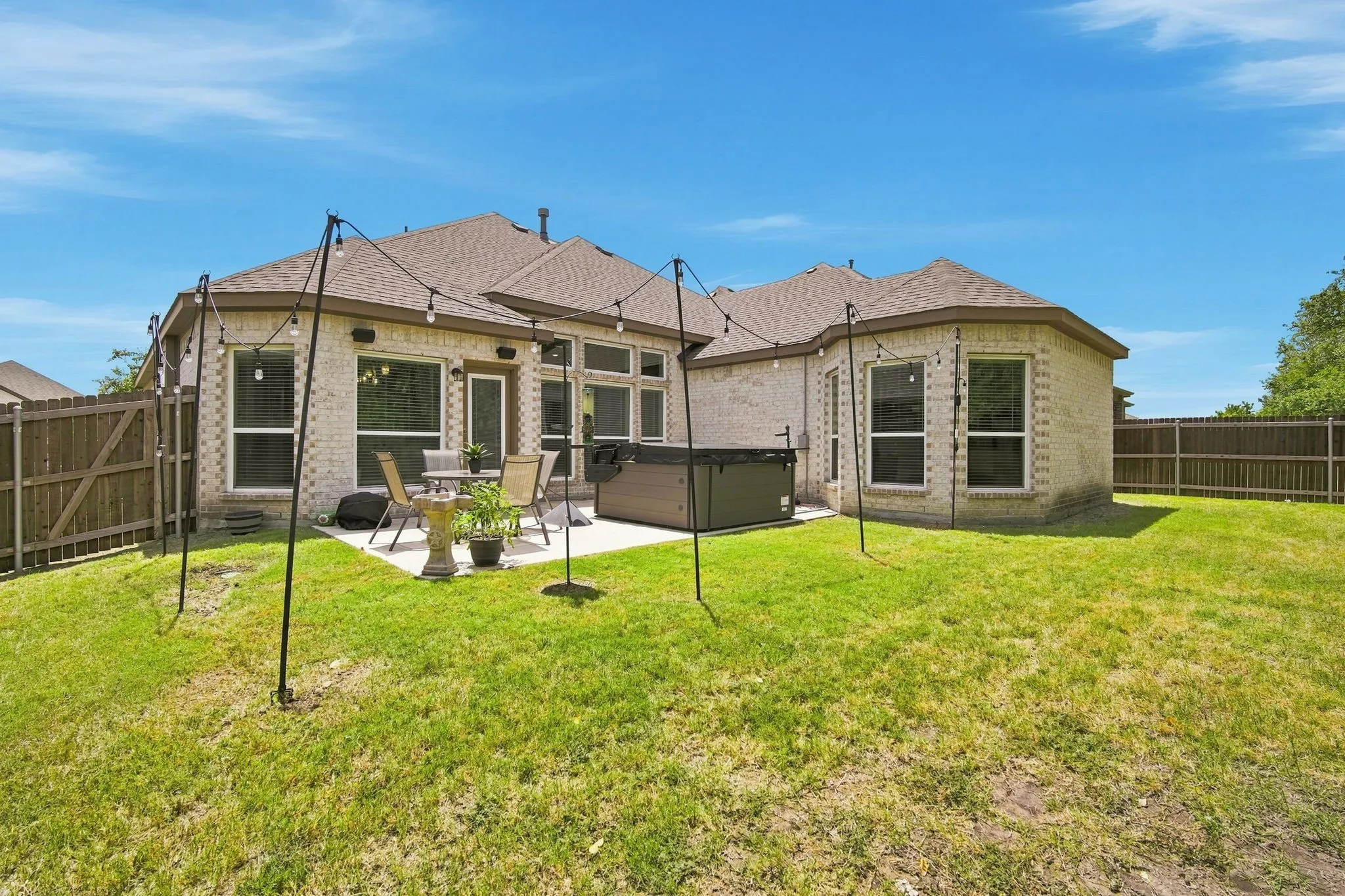 Backyard has sprinkler system and full perimeter fencing