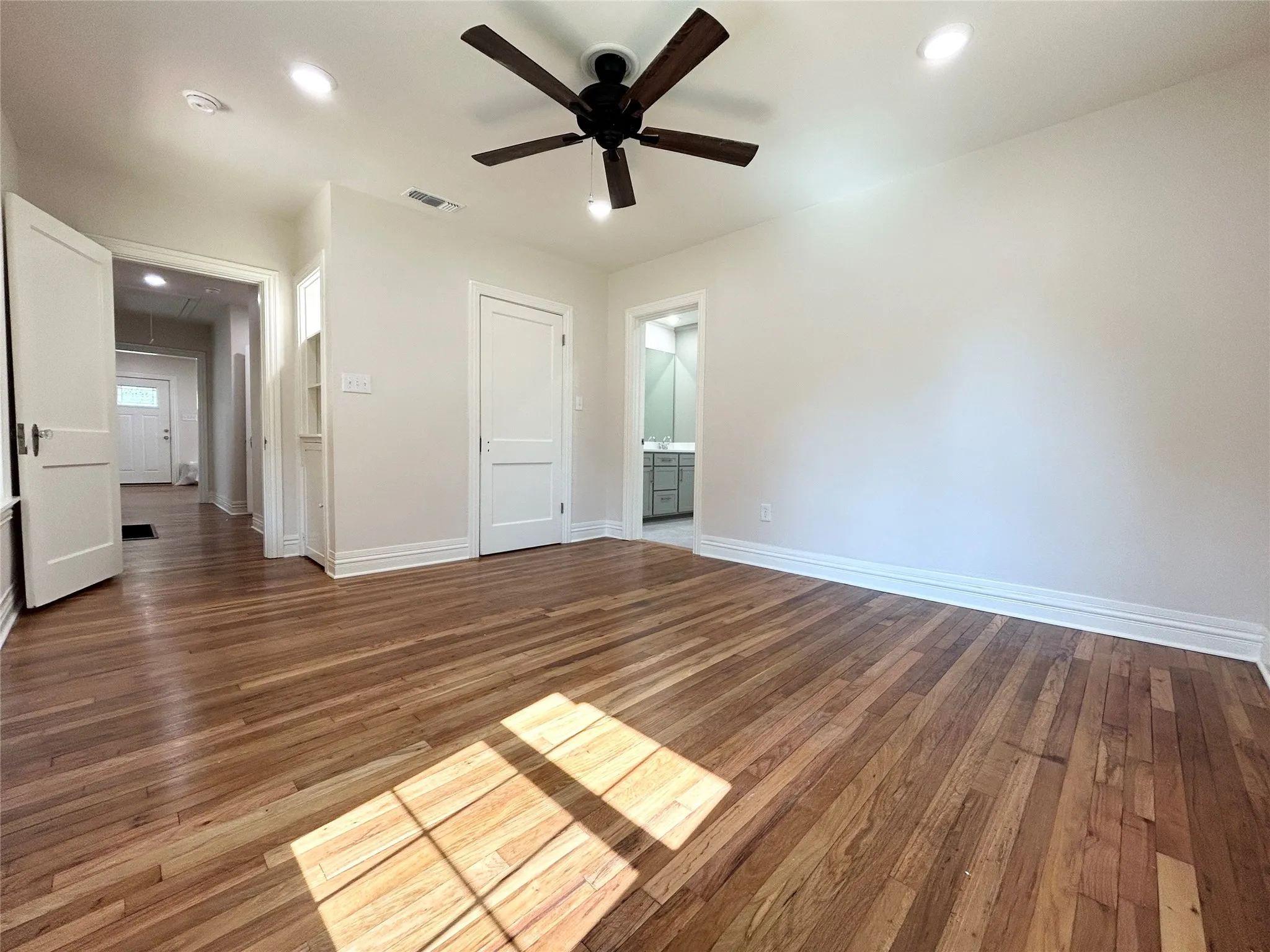 Primary bedroom with gorgeous original hardwood flooring