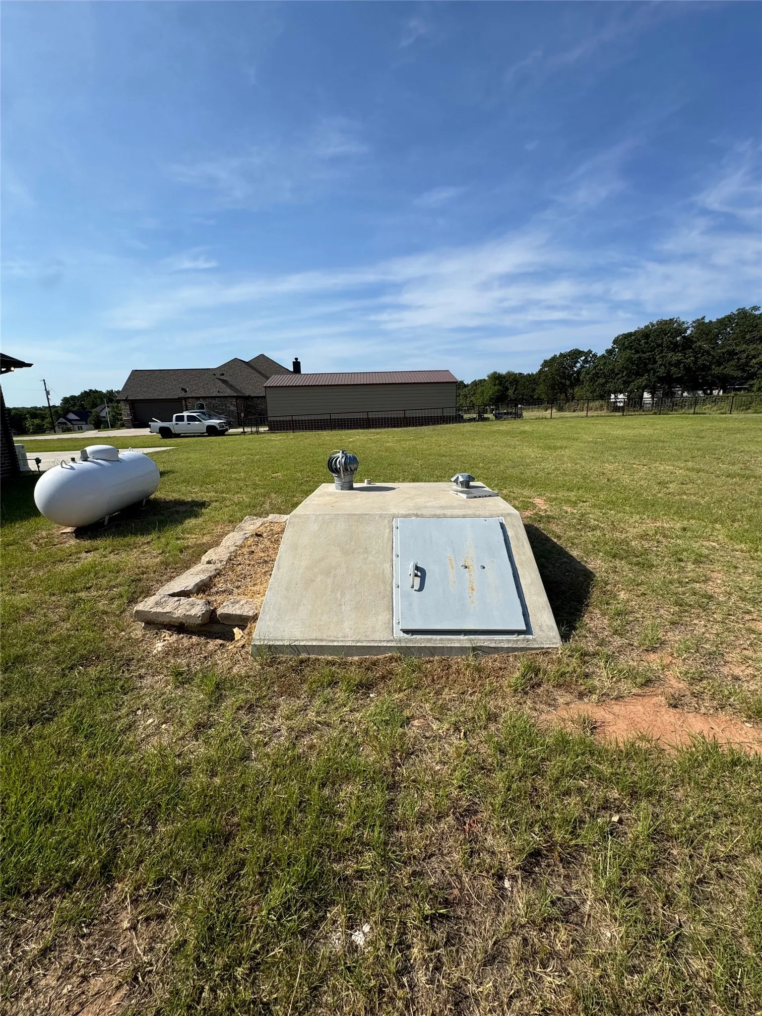 Concrete utility enclosure with metal access door