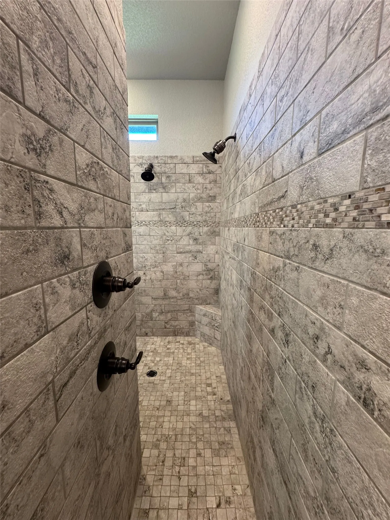 Walk-in shower with tiled walls and floor