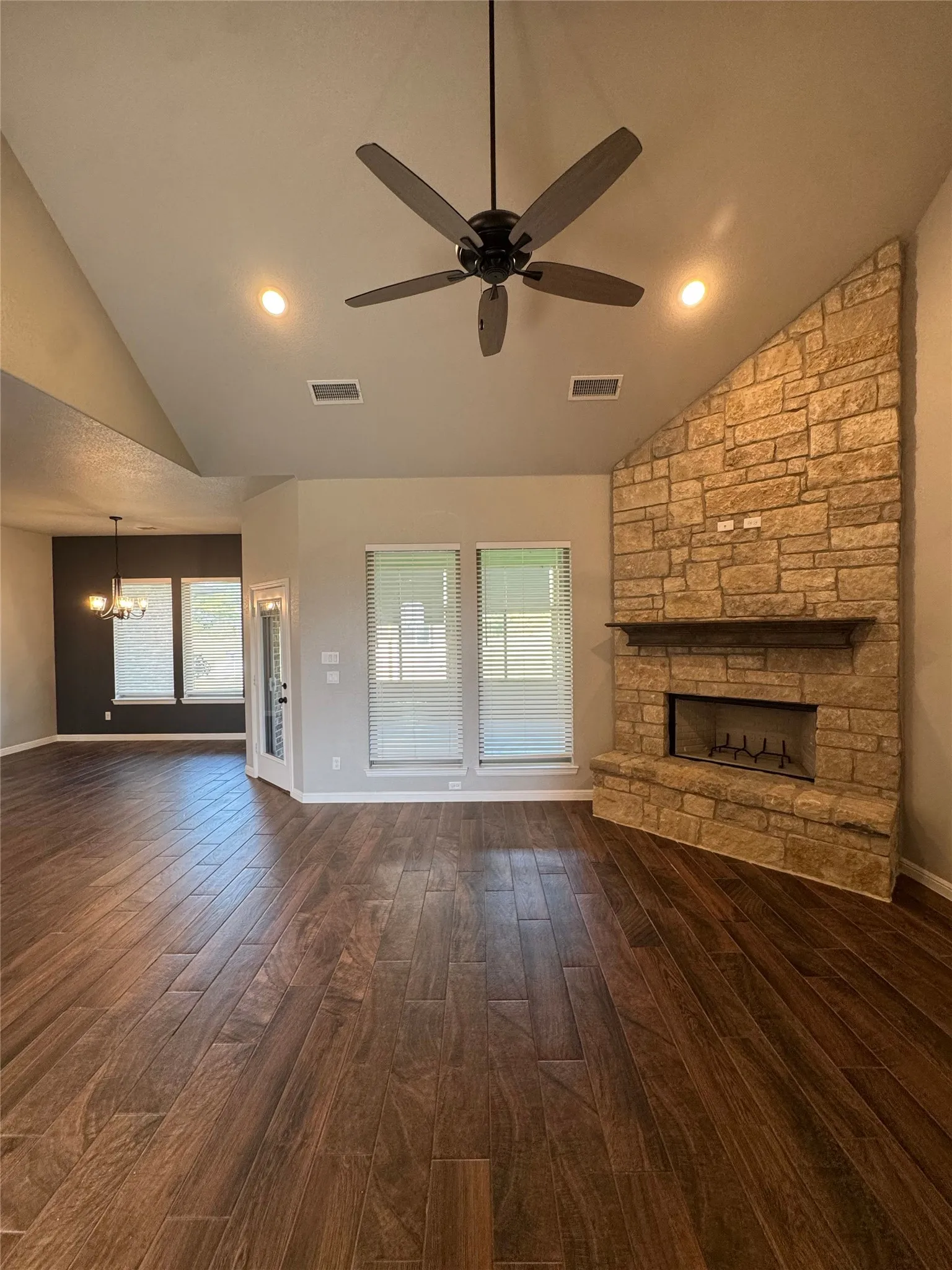 Vaulted ceiling with recessed lighting and ceiling fan