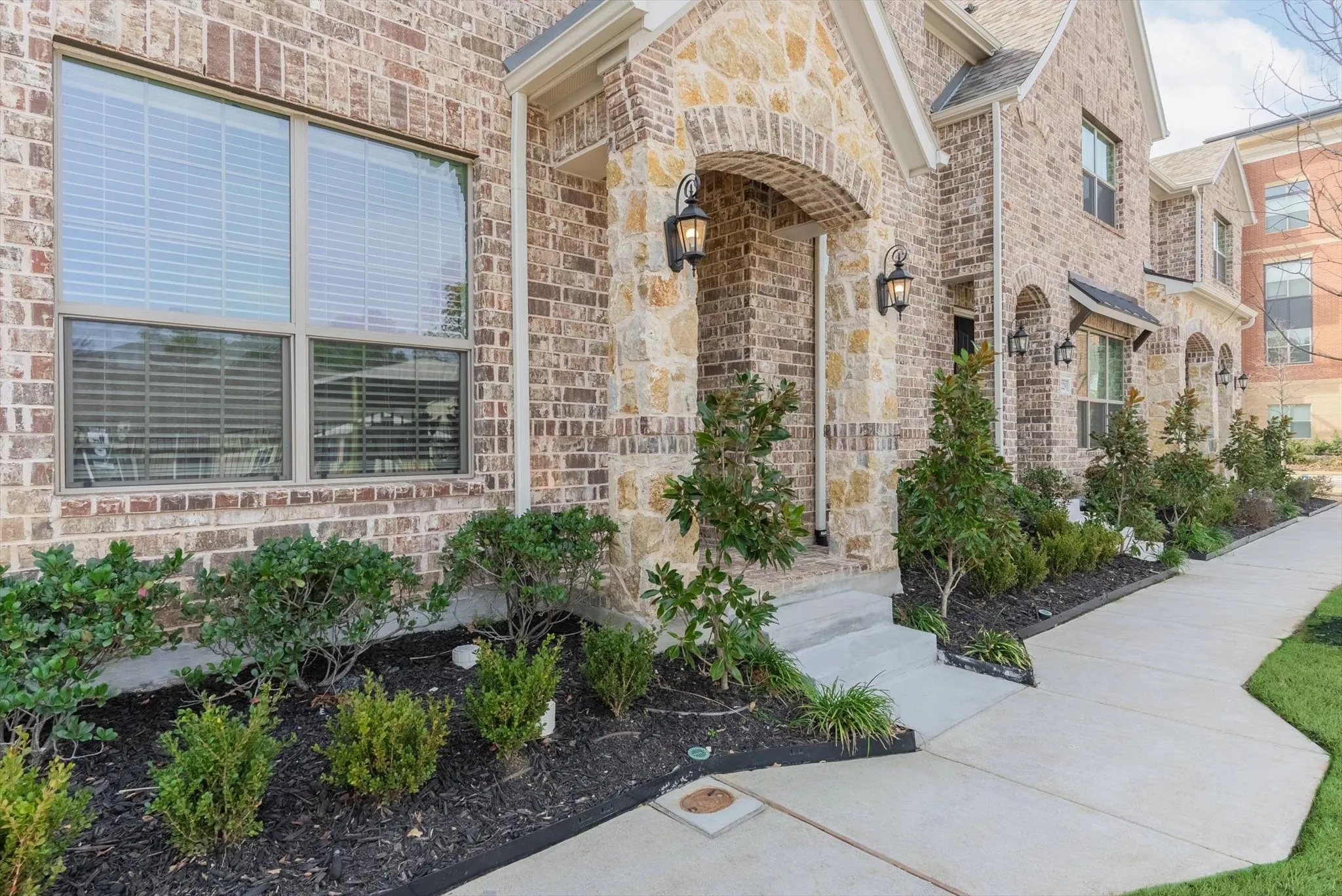 Brick and stone exterior with arched entryway