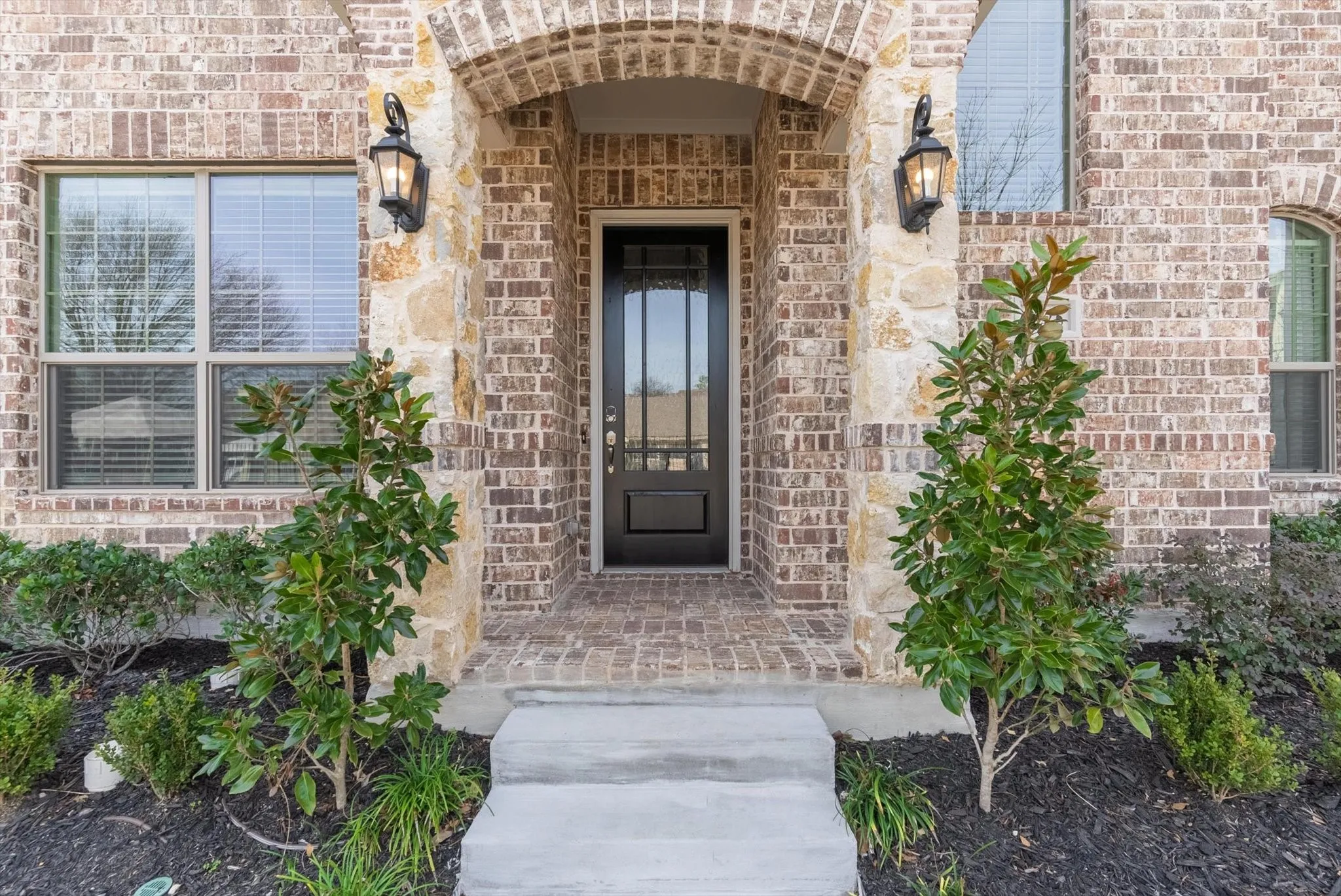 Brick and stone facade with an arched entryway