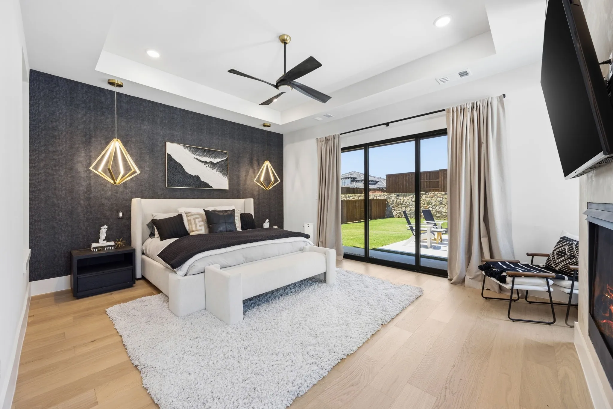 Primary bedroom with slider doors and fireplace