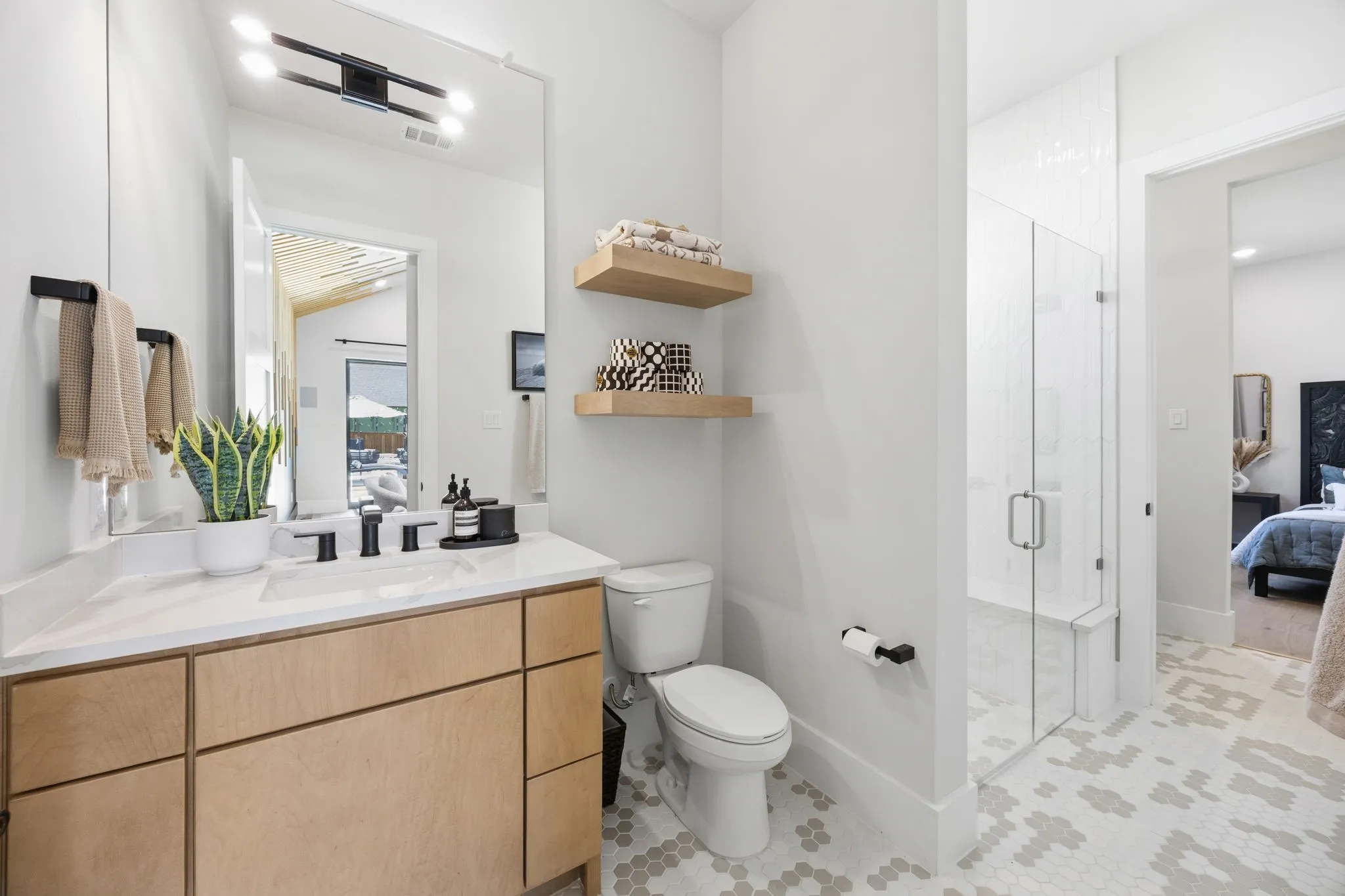 Pool bath connects entertainment room to the first floor guest suite with its own vanity and sink.