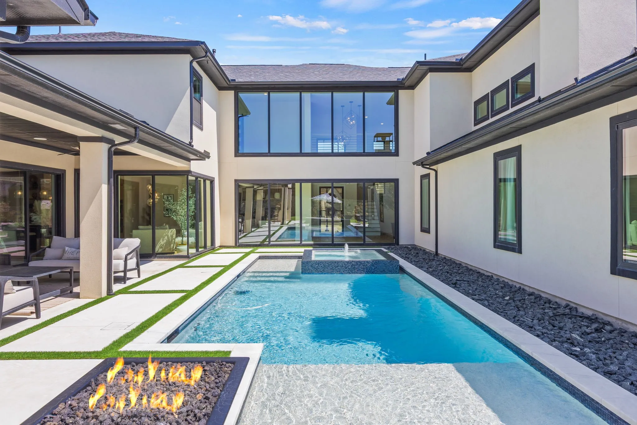 The pool is tucked into the home for privacy! Plus the glass windows surrounding the pool create gorgeous views from all areas of the home!
