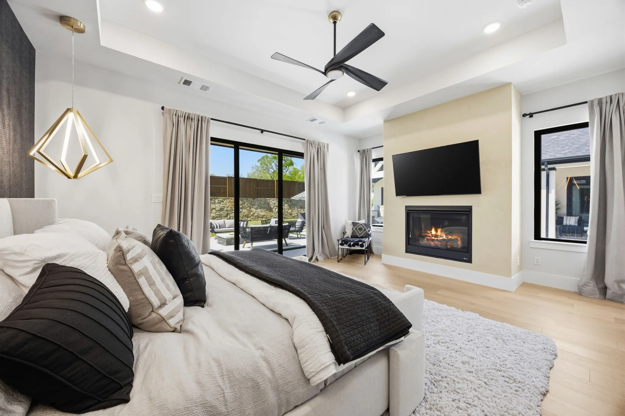 Primary Bedroom with fireplace and slider doors out to the patio.