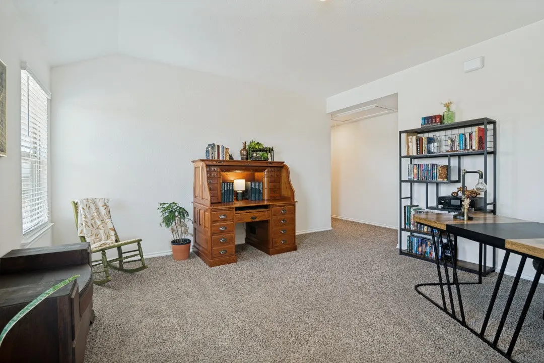 Vaulted ceiling, neutral wall tones, carpeted flooring, window with blinds, and recessed lighting