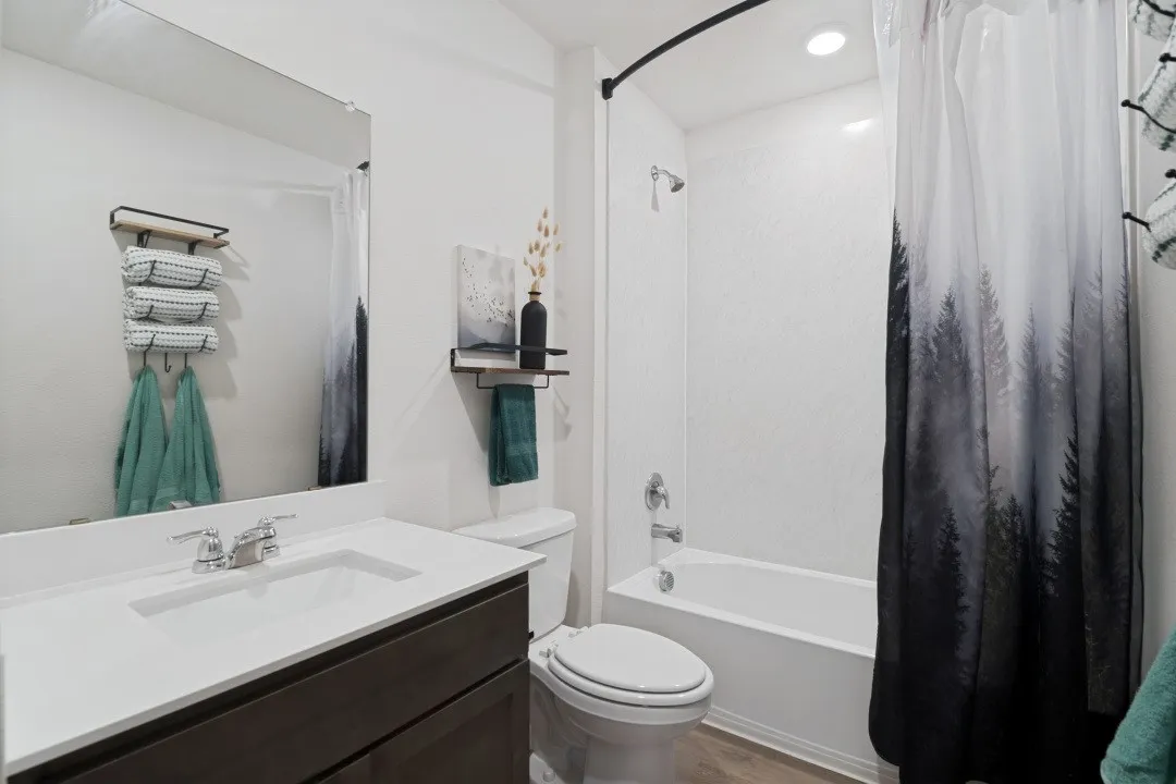 Built-in vanity with a white countertop and undermount sink