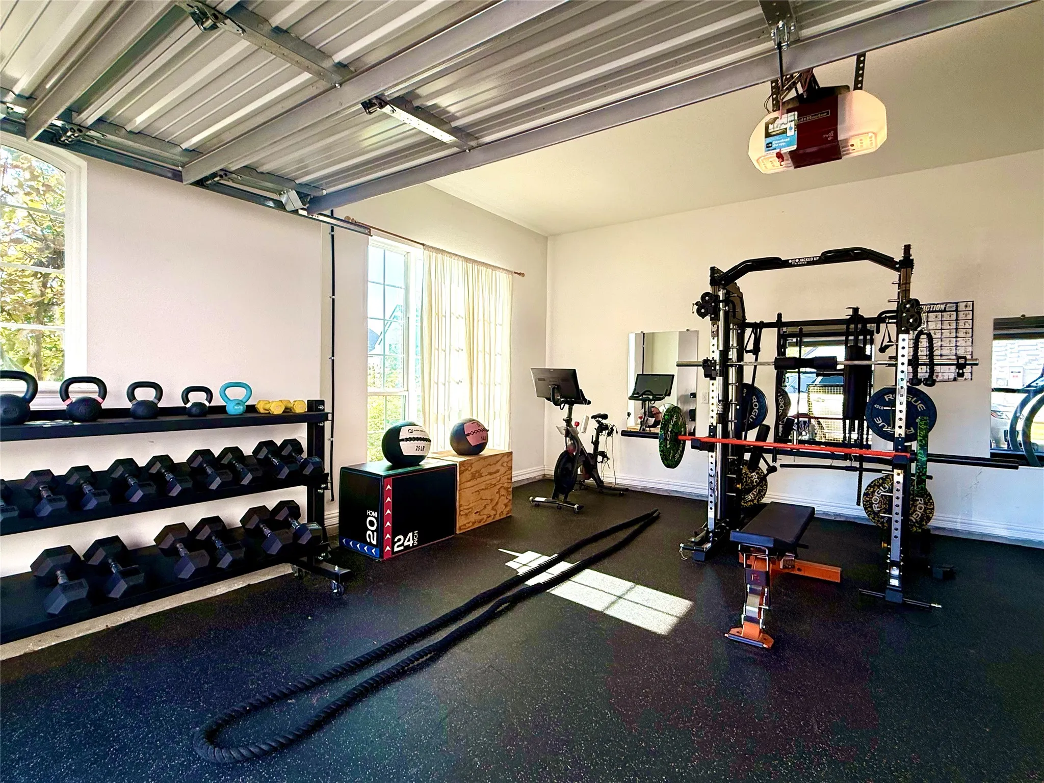 Home gym located in one of the two car garages. The other two car bay is perfect for parking the cars