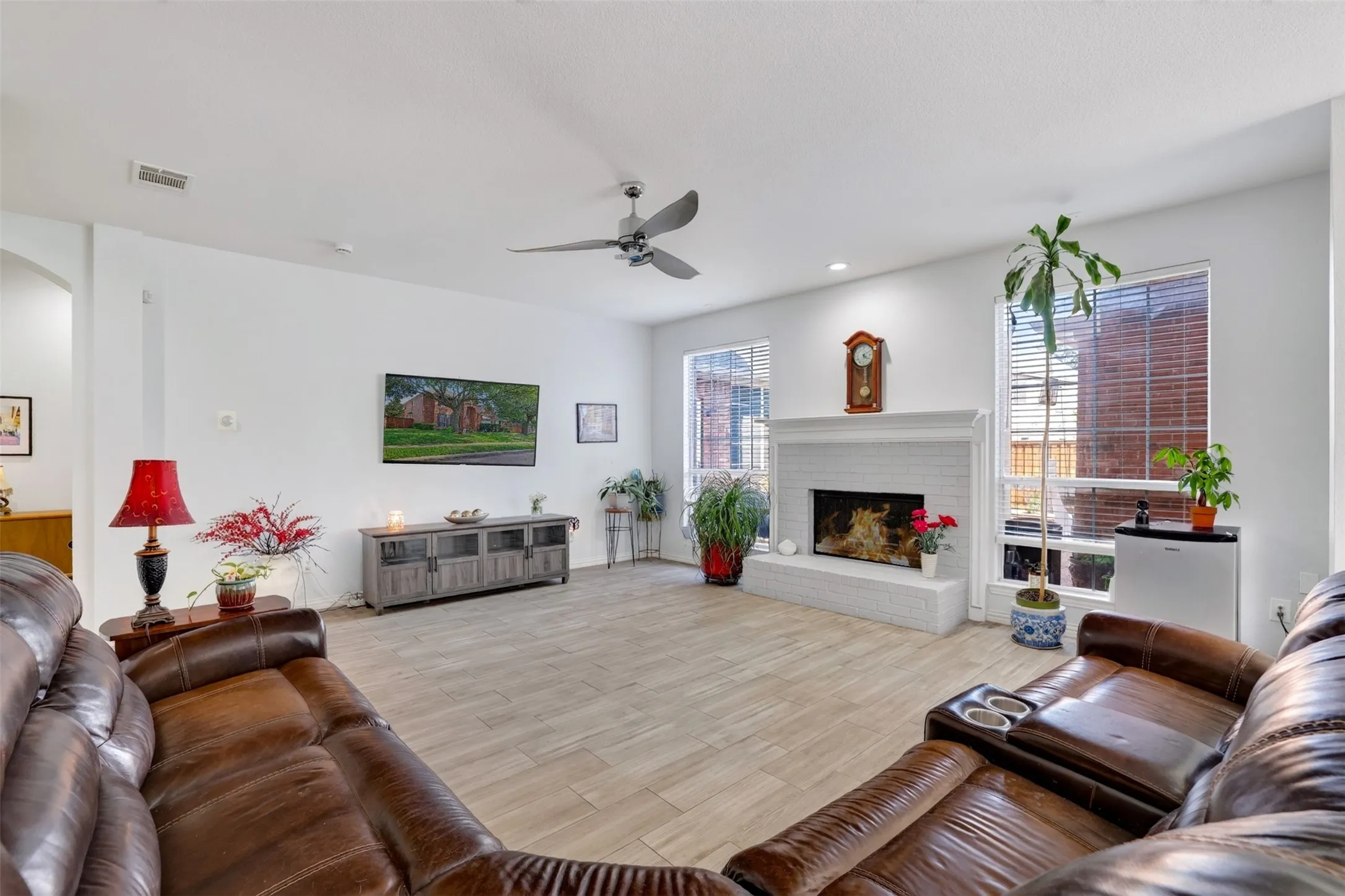 Spacious family room with a gas log fireplace, offering warmth, comfort, and an inviting atmosphere year-round.