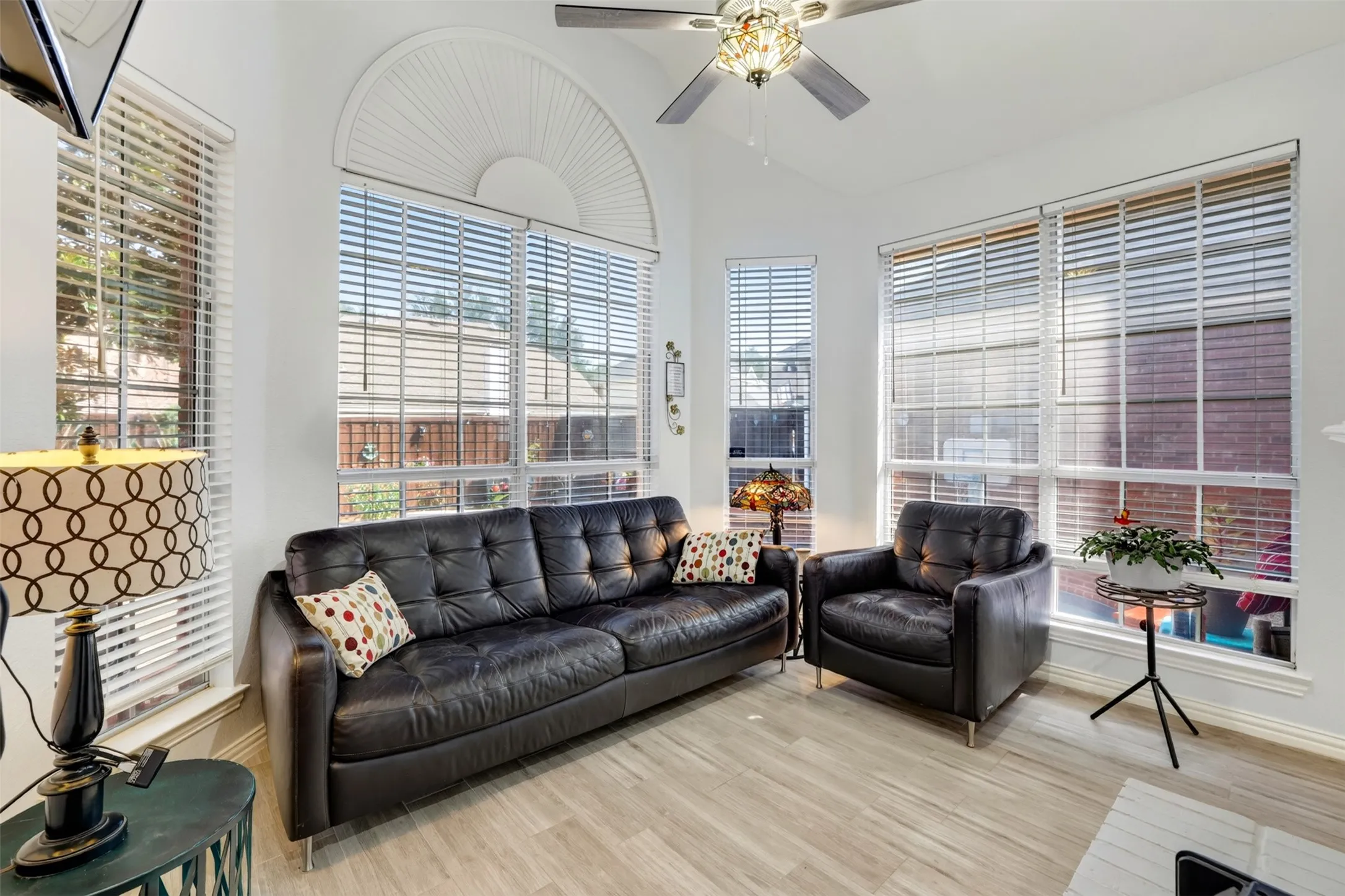 Sitting area attached to the primary bedroom separated by a gas fireplace.