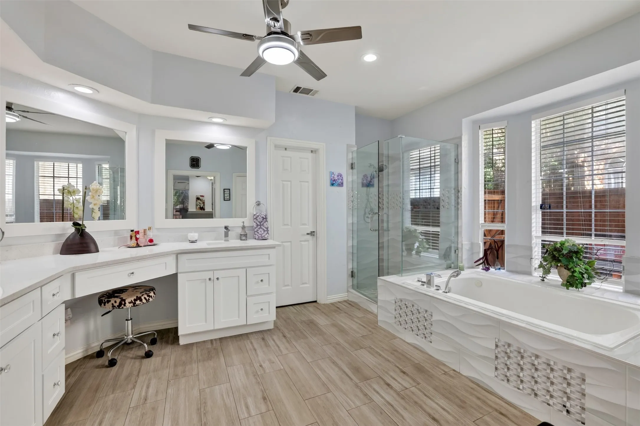 Bright and airy, the bedroom-sized primary bath offers abundant natural light and exceptional space for everyday luxury.