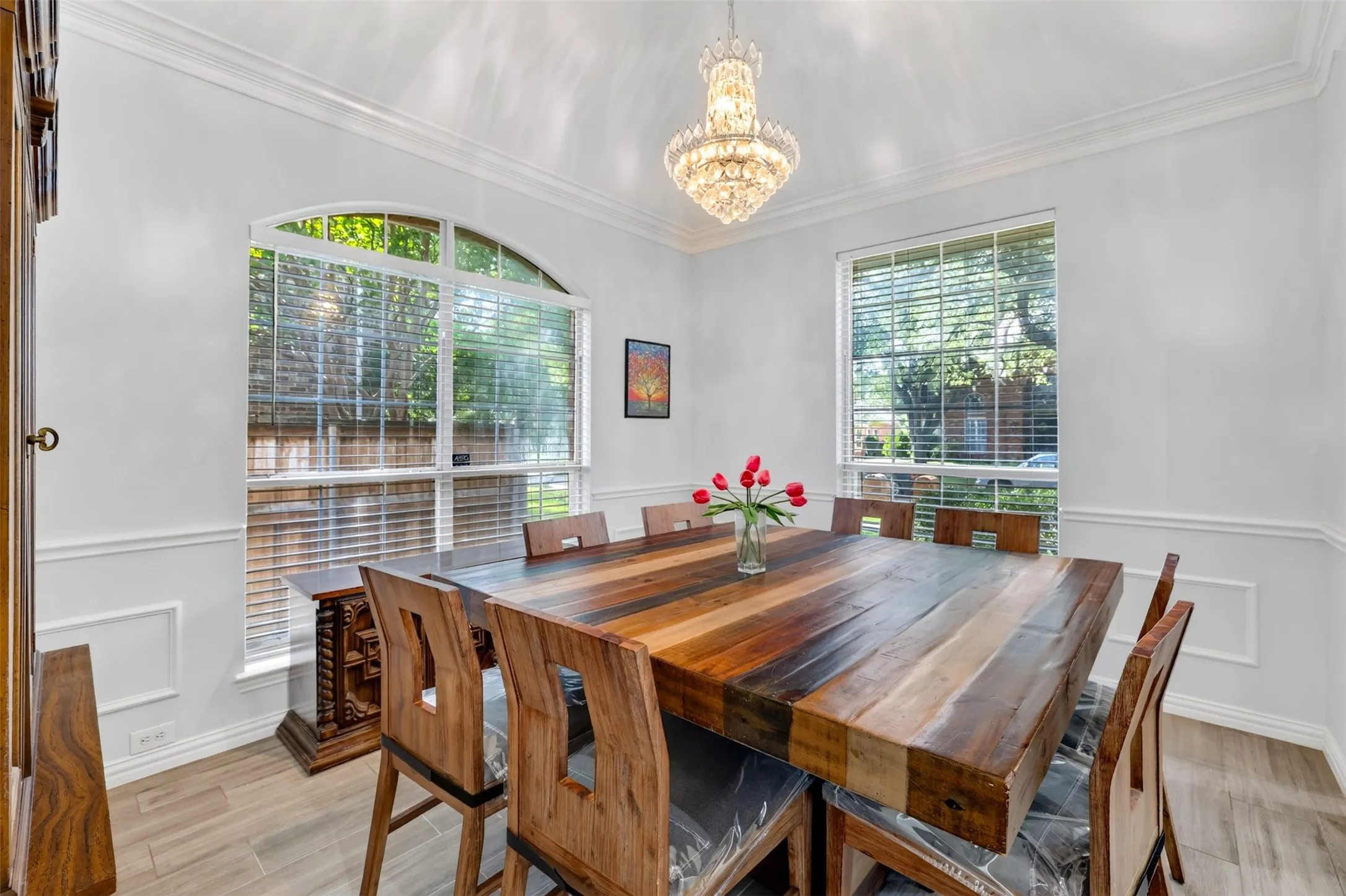 Timeless formal dining room with an eye-catching chandelier, creating the perfect setting for special occasions.