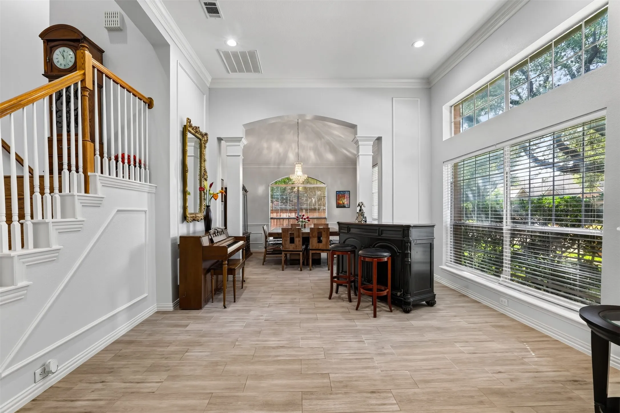 Elegant formal living open to the dining room with a wall of windows.