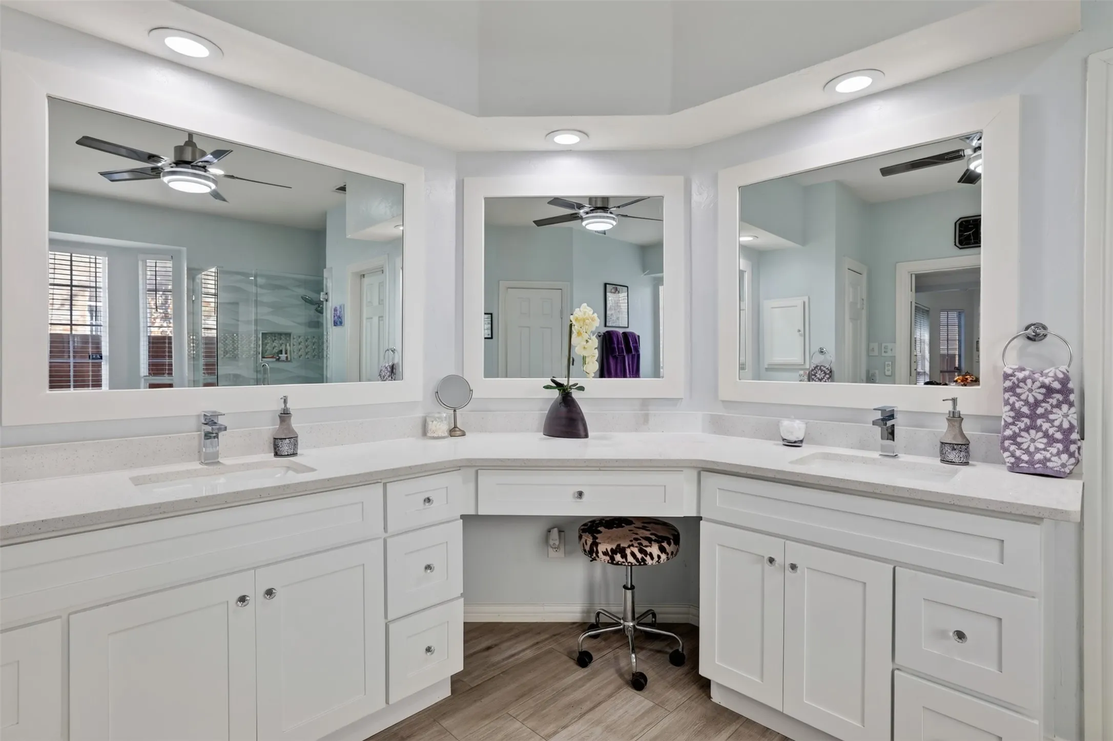 The remodeled primary bath features elevated-height quartz vanities, offering both comfort and style.