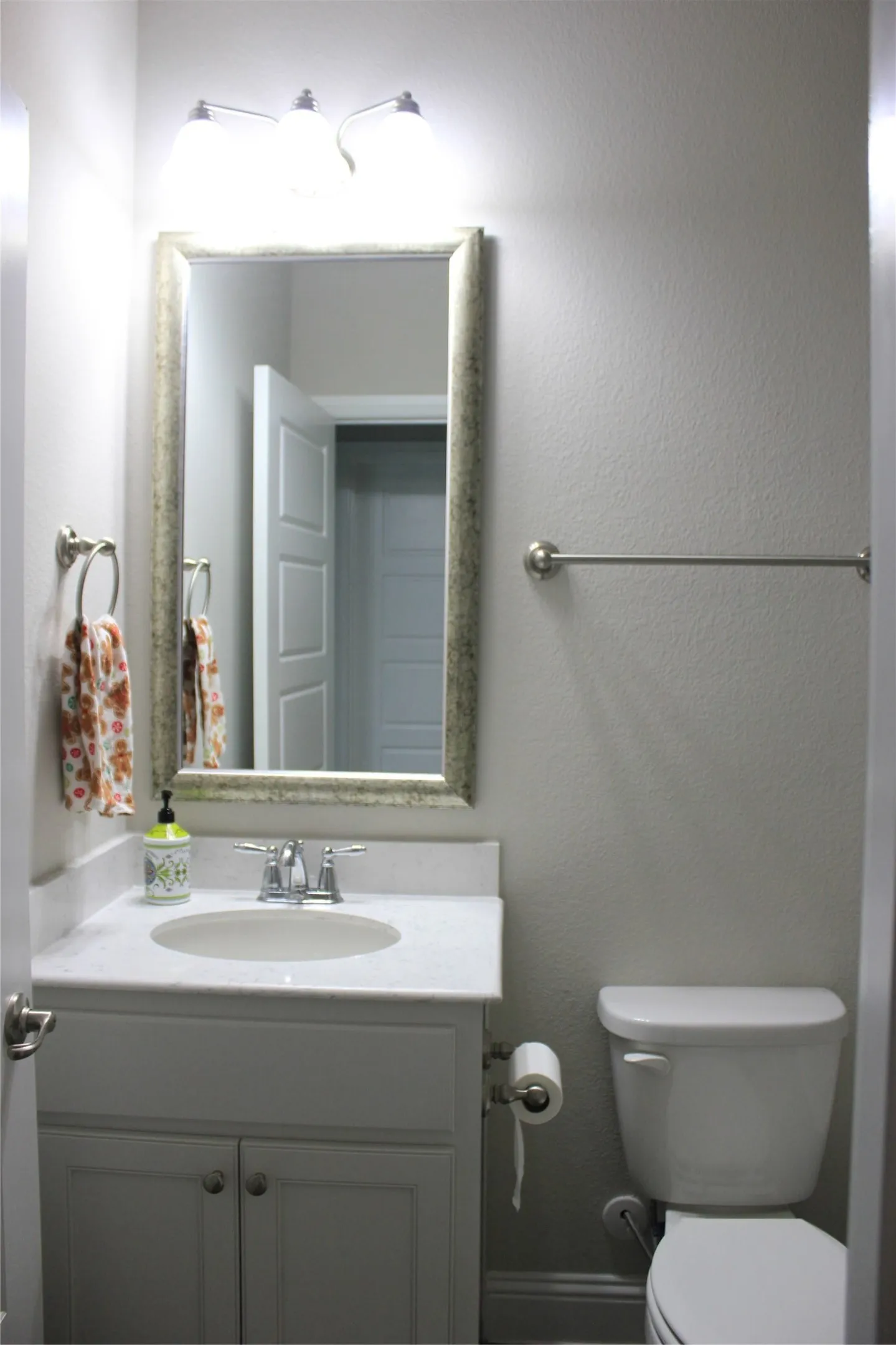 2nd bath with White vanity with dual cabinet doors, integrated sink, chrome faucet, and coordinating hardware