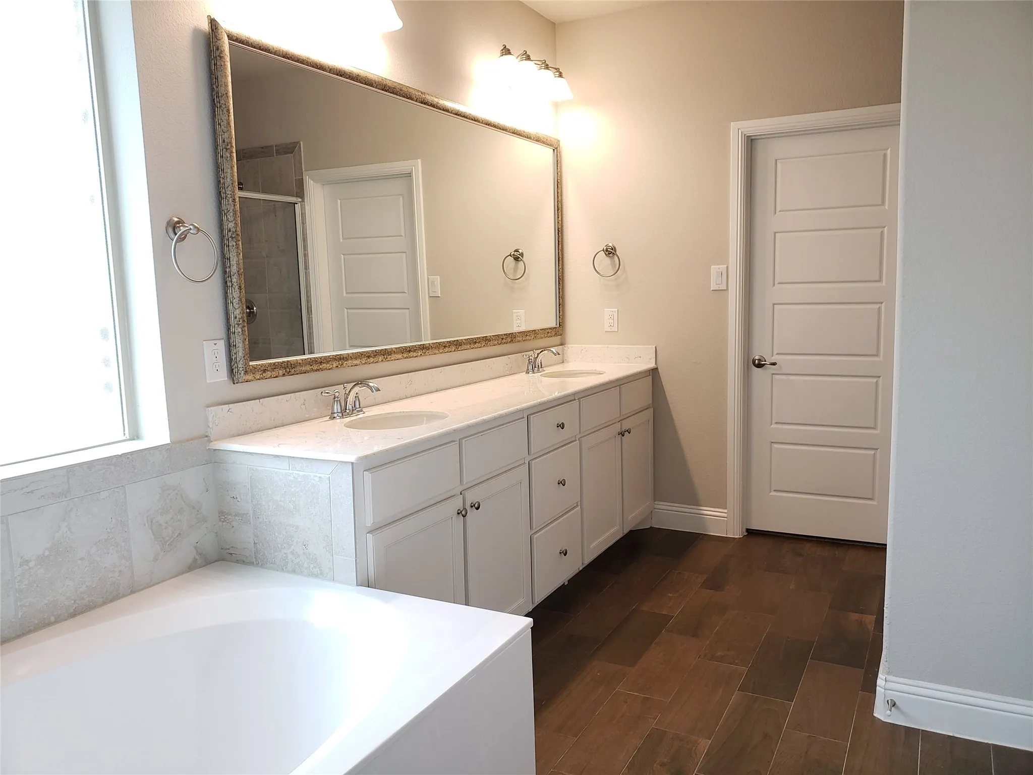 Primary Bath with Dual vanity with white cabinetry, light-colored countertops, and undermount sinks