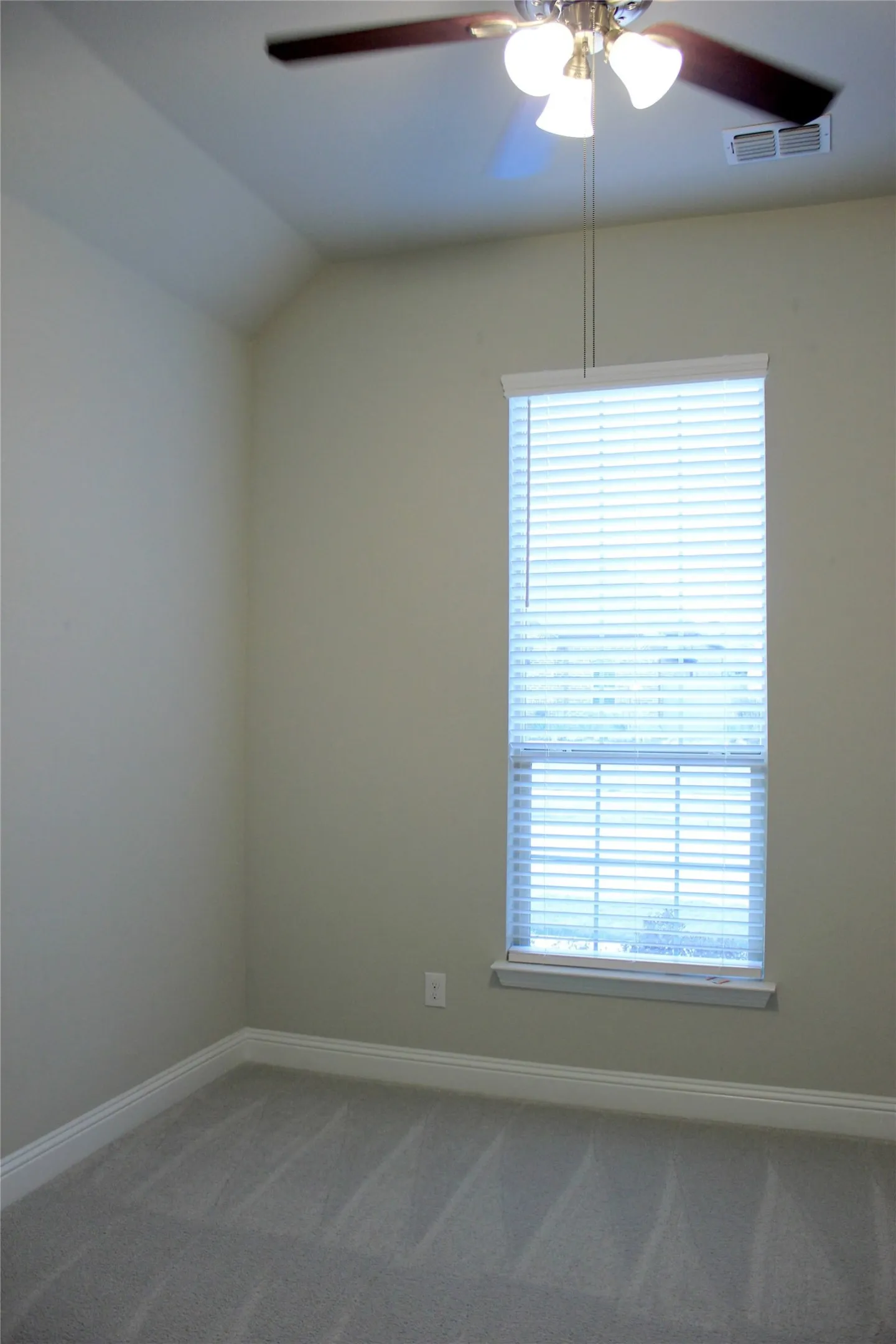 3re Bedroom Vaulted ceiling, ceiling fan with light kit, window with blinds, and neutral carpeting
