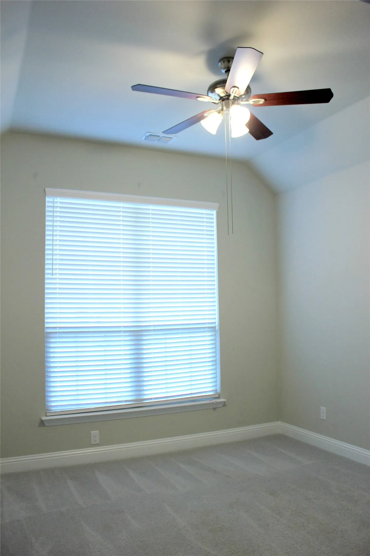 2nd bedroom Vaulted ceiling featuring a ceiling fan with light fixture, window with blinds, and carpeted flooring