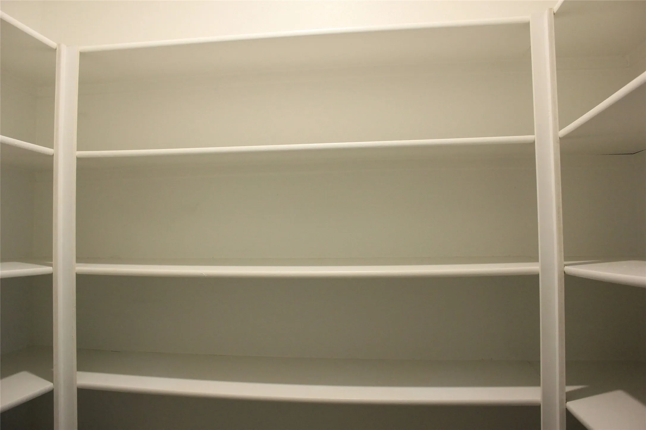 Built-in shelving with multiple levels and white finishes