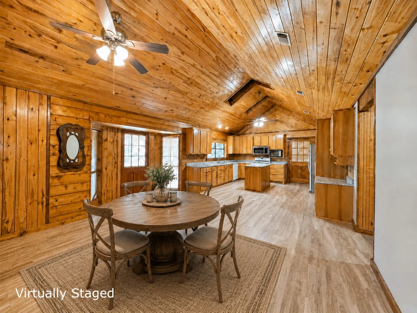Vaulted wood-paneled ceiling with exposed beams and ceiling fans