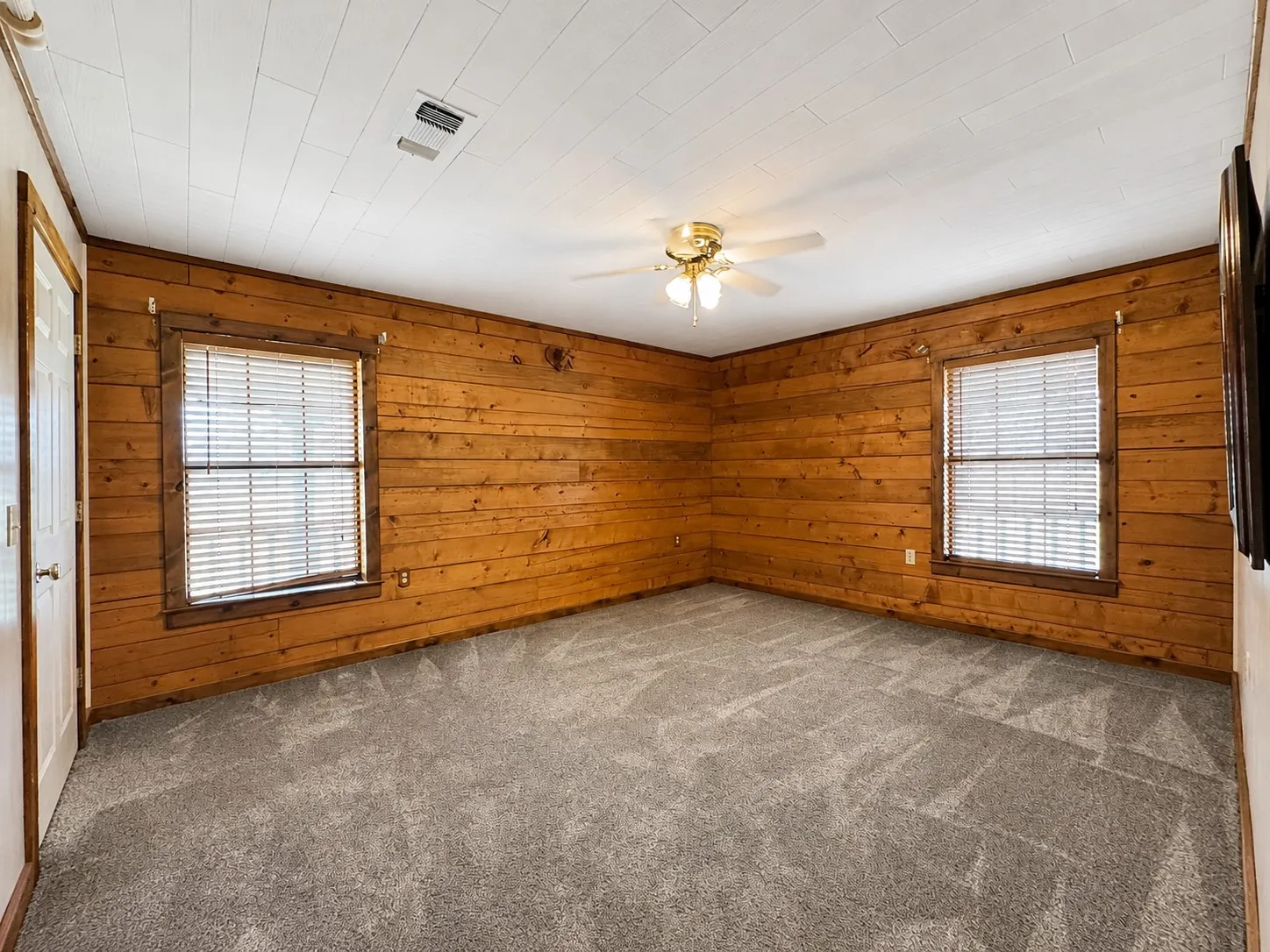 Interior room featuring wood paneling on walls