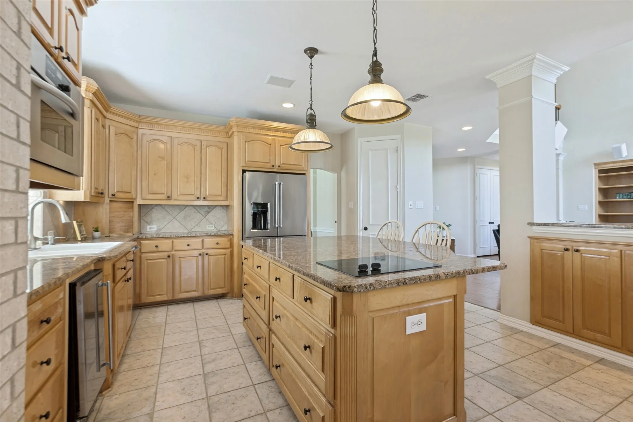 The kitchen island has a two burner electric cooktop to keep food warm for a buffet or entertaining