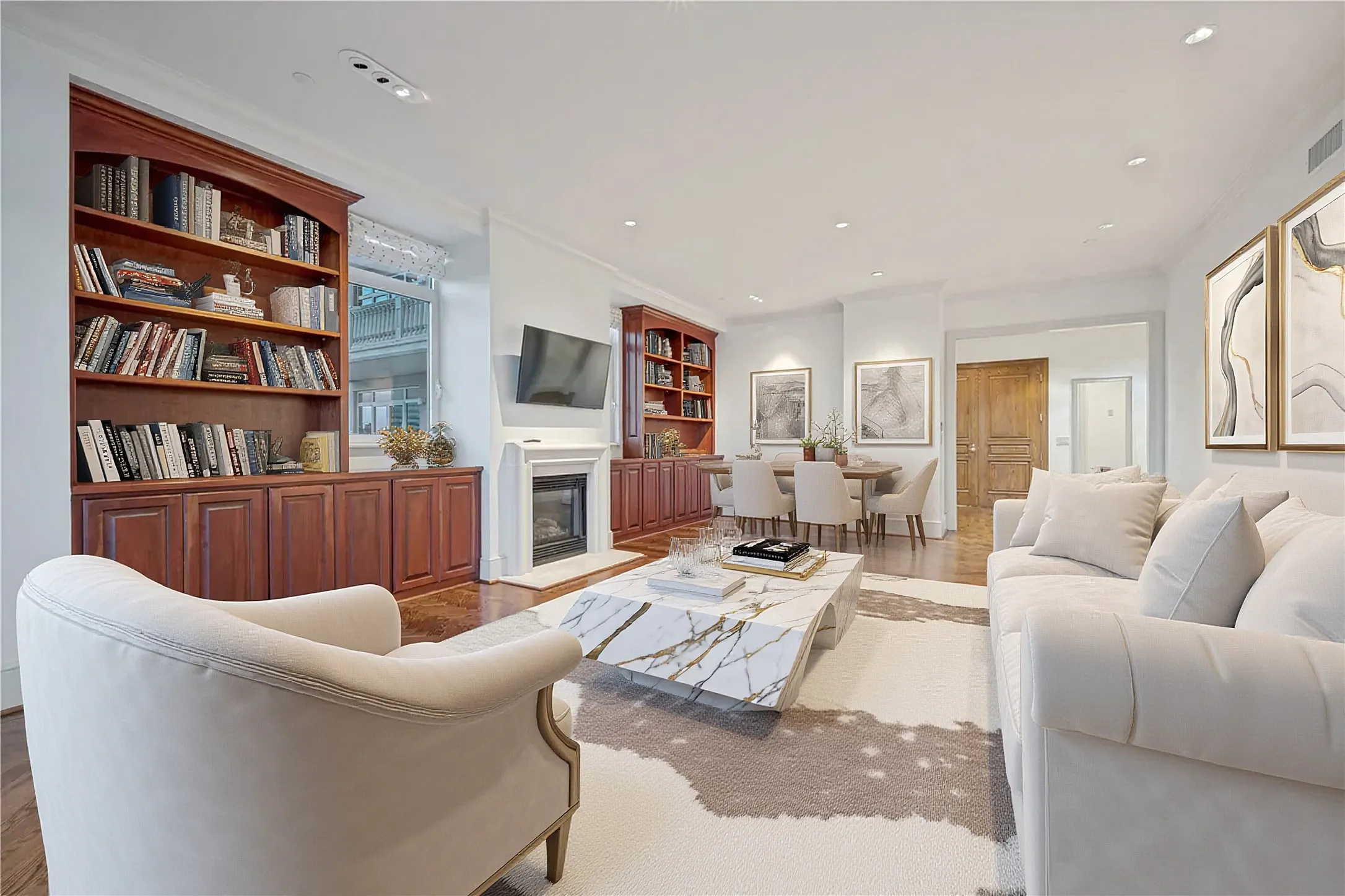 View of living room from balcony doors to the foyer with lighting for artwork on right hand wall (virtually staged)