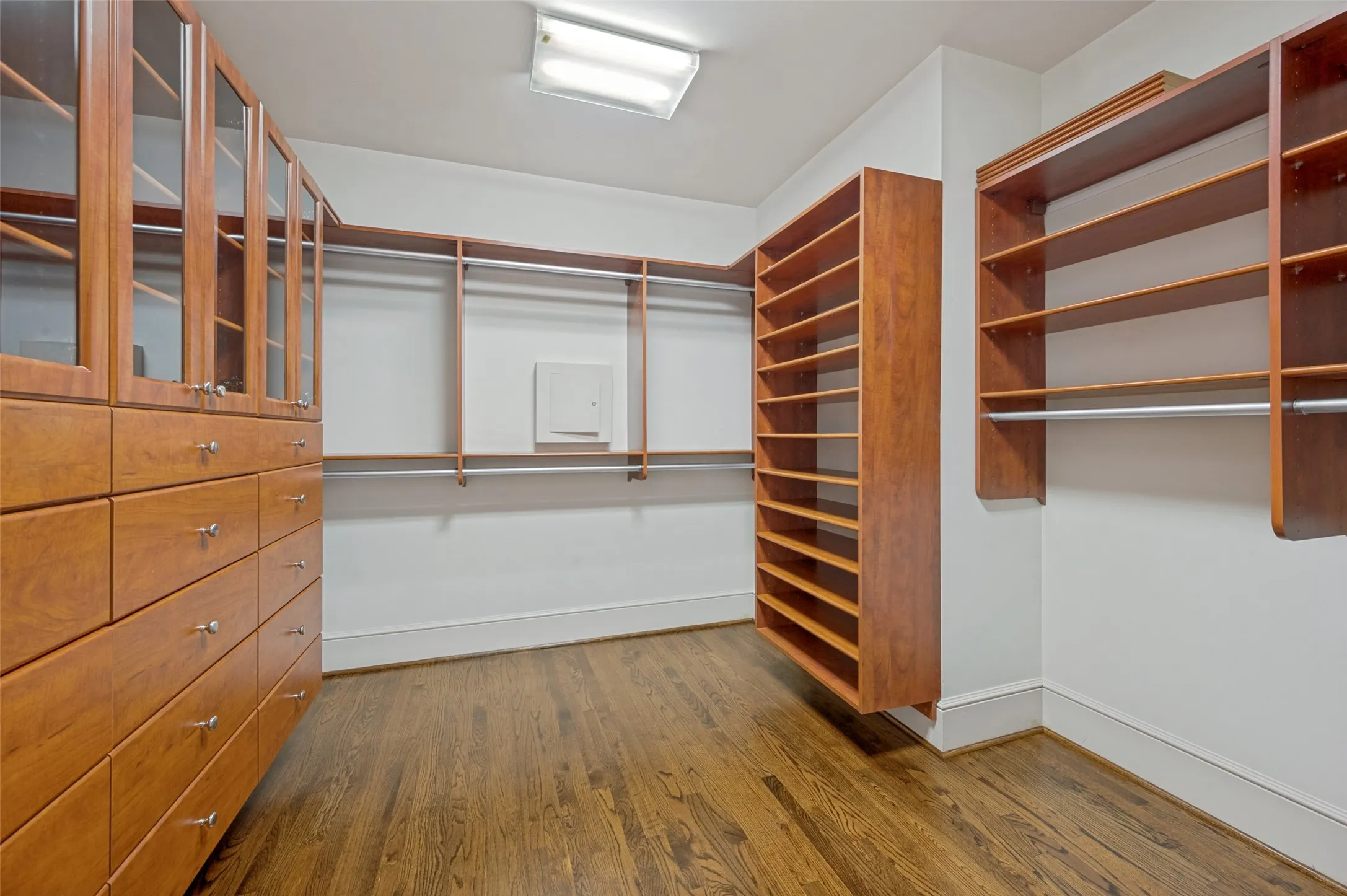 Custom closet in first primary bath with soft close drawers, cabinets, and shelves for shoes and handbags.