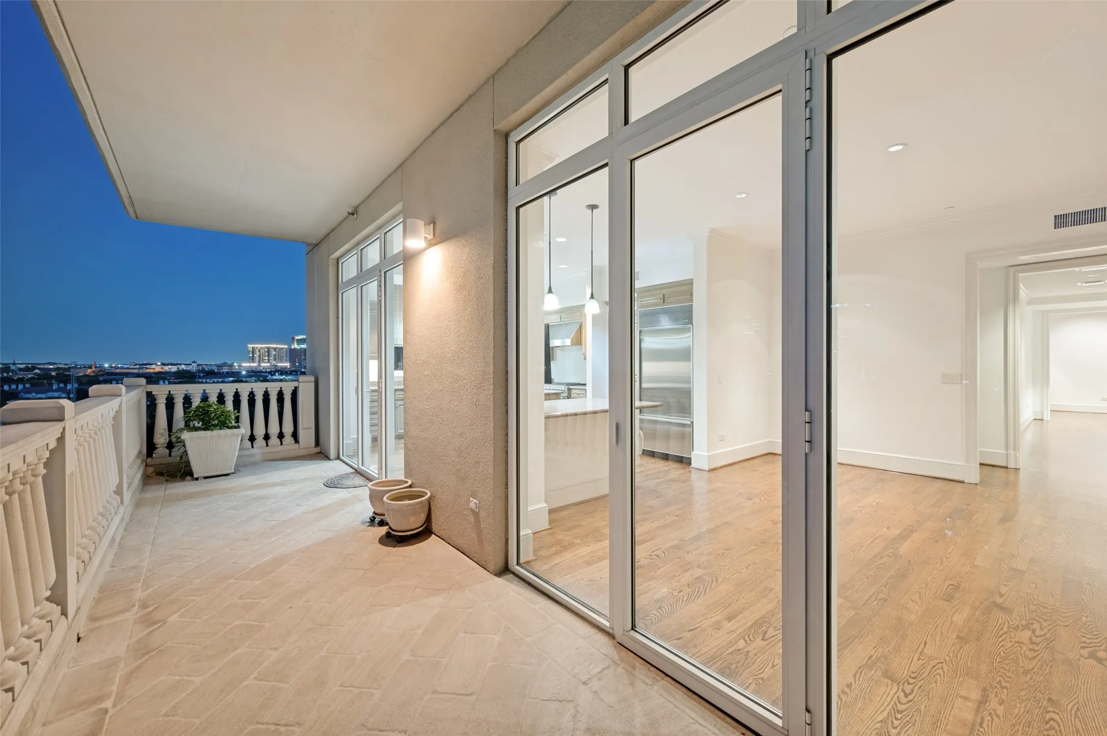 View of balcony showing secondary bedroom, dining room and kitchen facing west