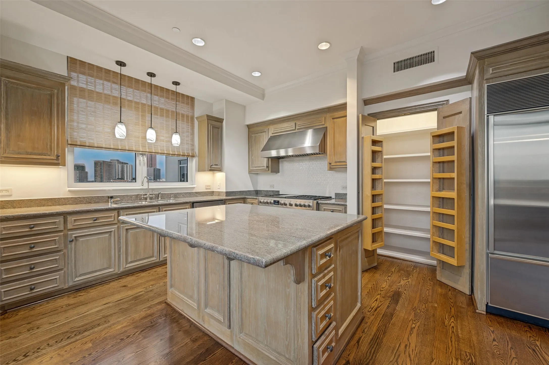 View of kitchen with pantry open to show significant storage space