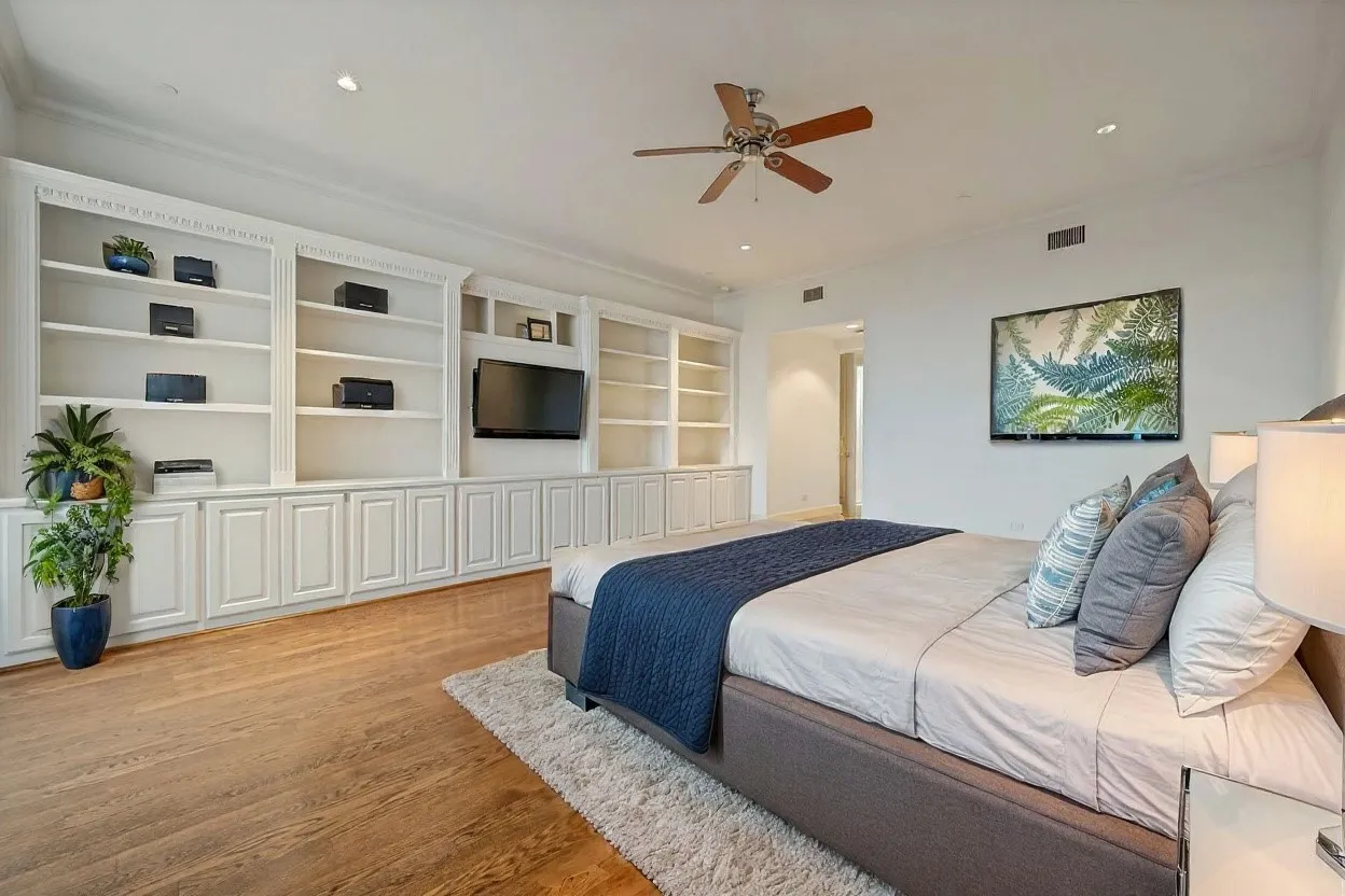 View from far corner of primary bedroom to doorway into the bedroom (virtually staged)