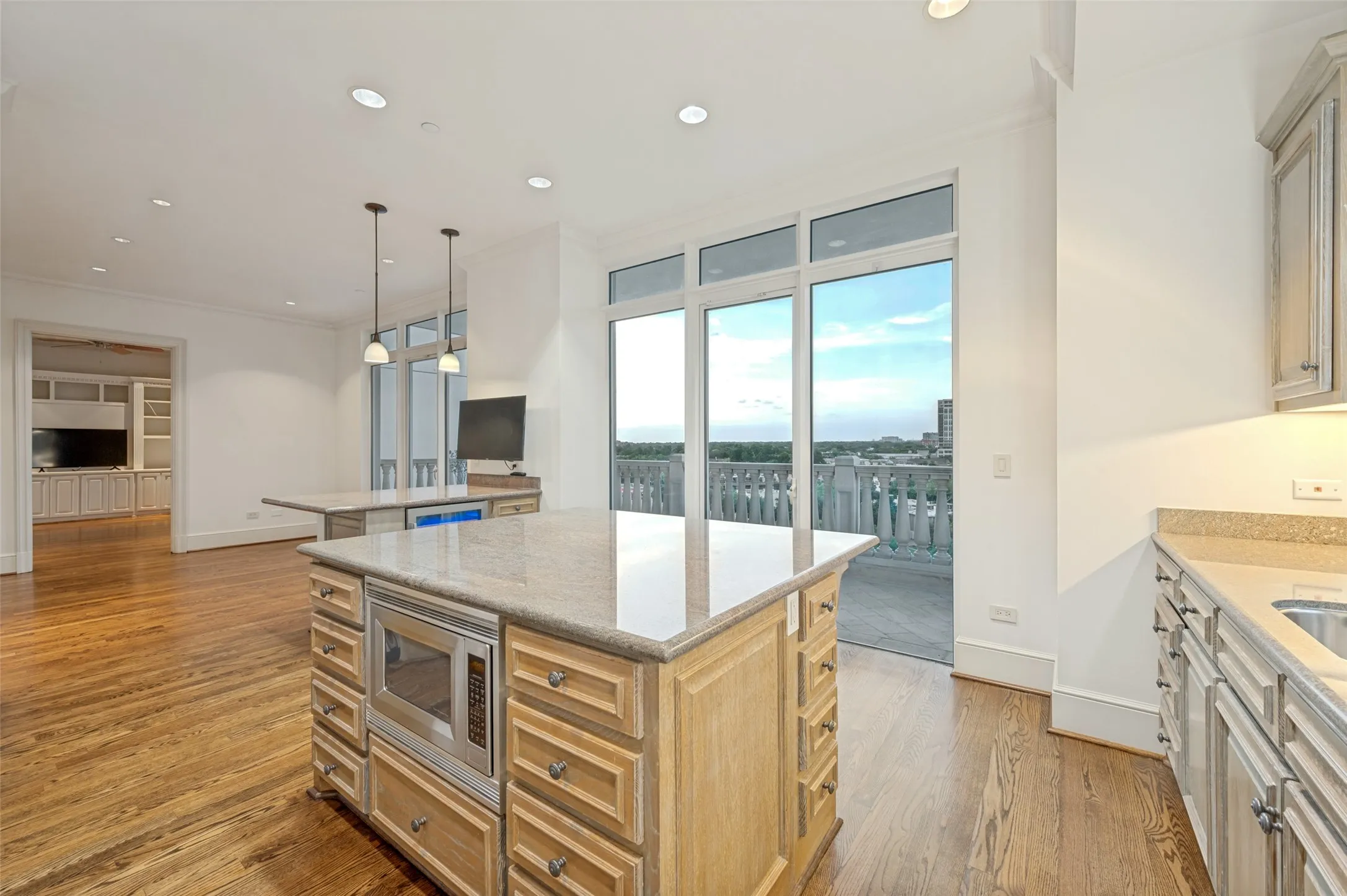 View from the kitchen corner of the island and breakfast bar looking on to the west balcony