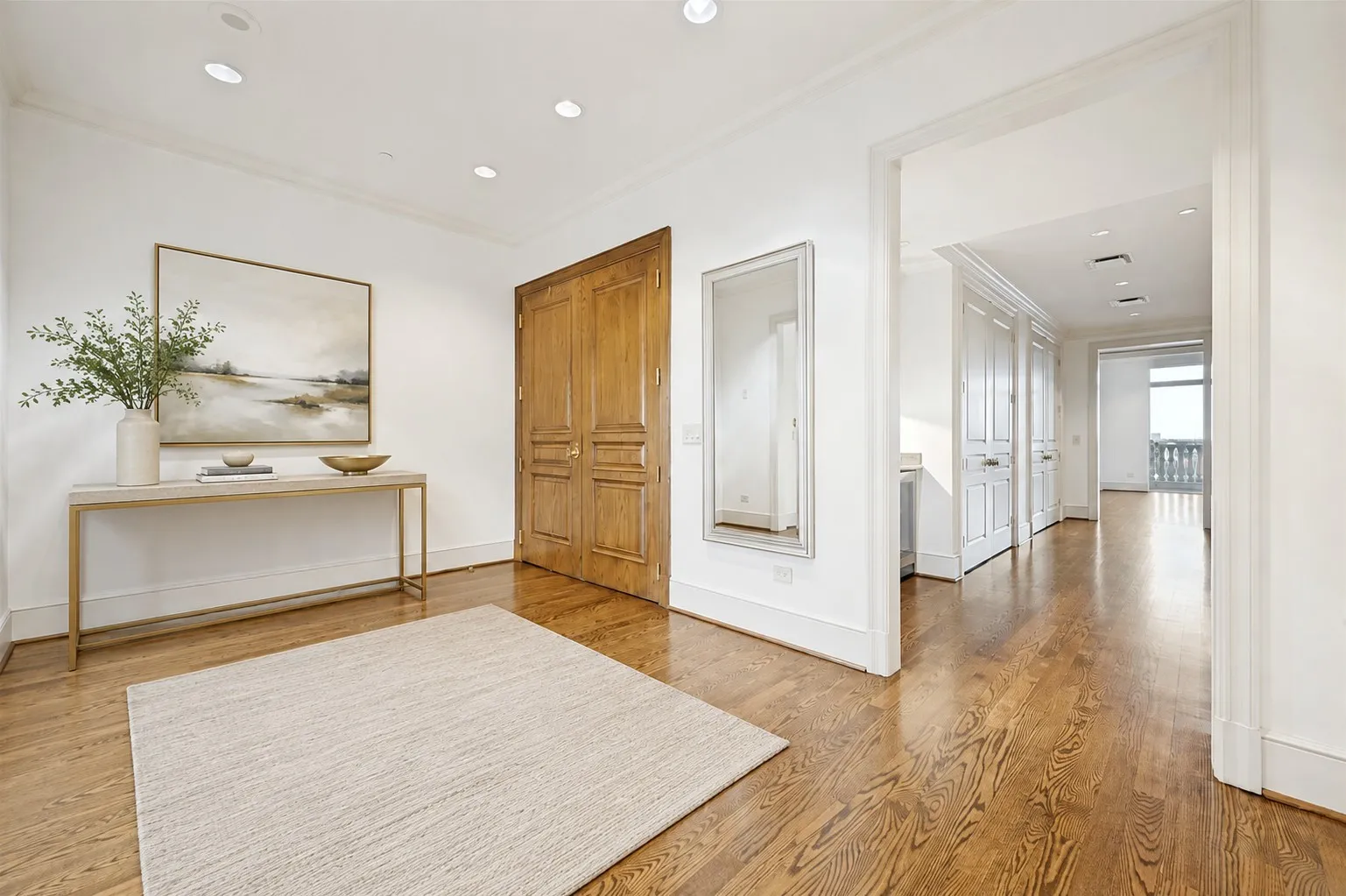 View of the foyer from the living room (virtually staged)