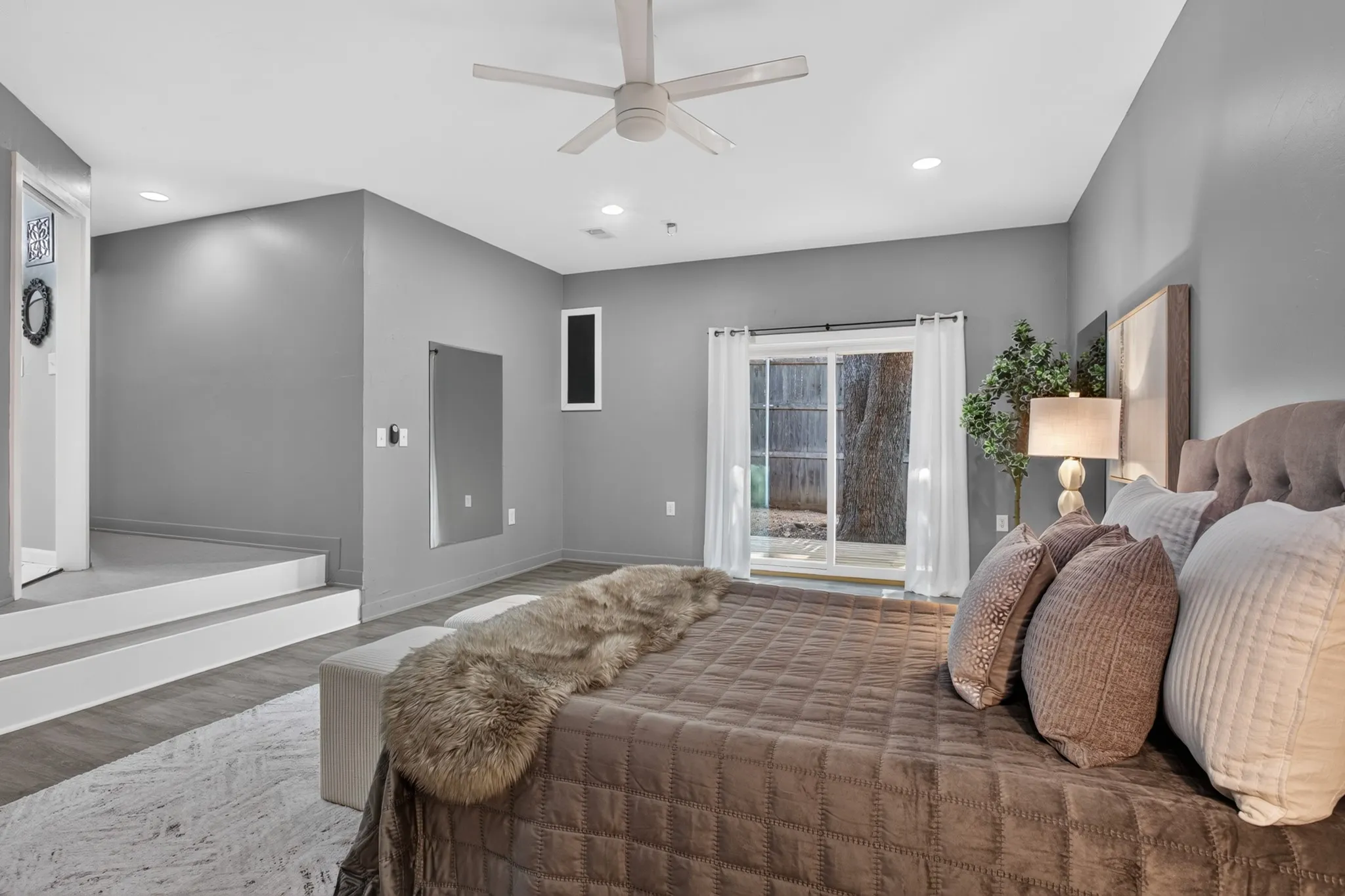 The main primary suite is a peaceful 20 x 22 retreat featuring picture windows, a custom walk-in closet with industrial pipe shelving and private access to its own covered patio. The beautifully remodeled ensuite bath features an oversized 11x8 seamless glass shower with designer tile.
