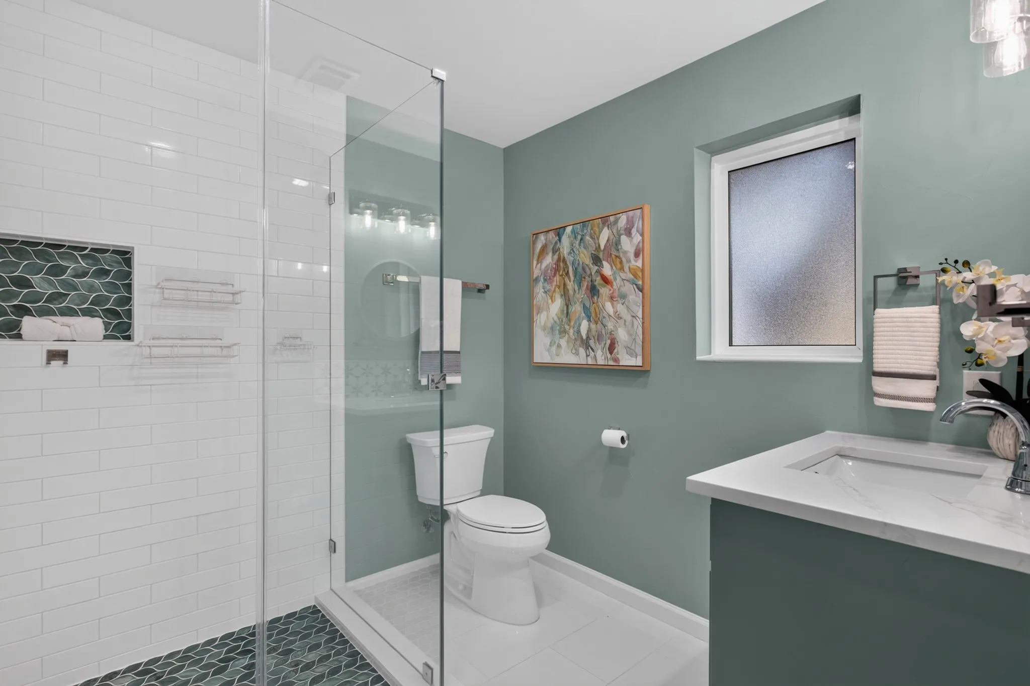 The second primary suite provides exceptional flexibility and ensuite bath showcases quartz, green leaf custom accented and subway tile surround the seamless glass shower, illuminated LED mirror updated lighting, large walk in closer with built ins.