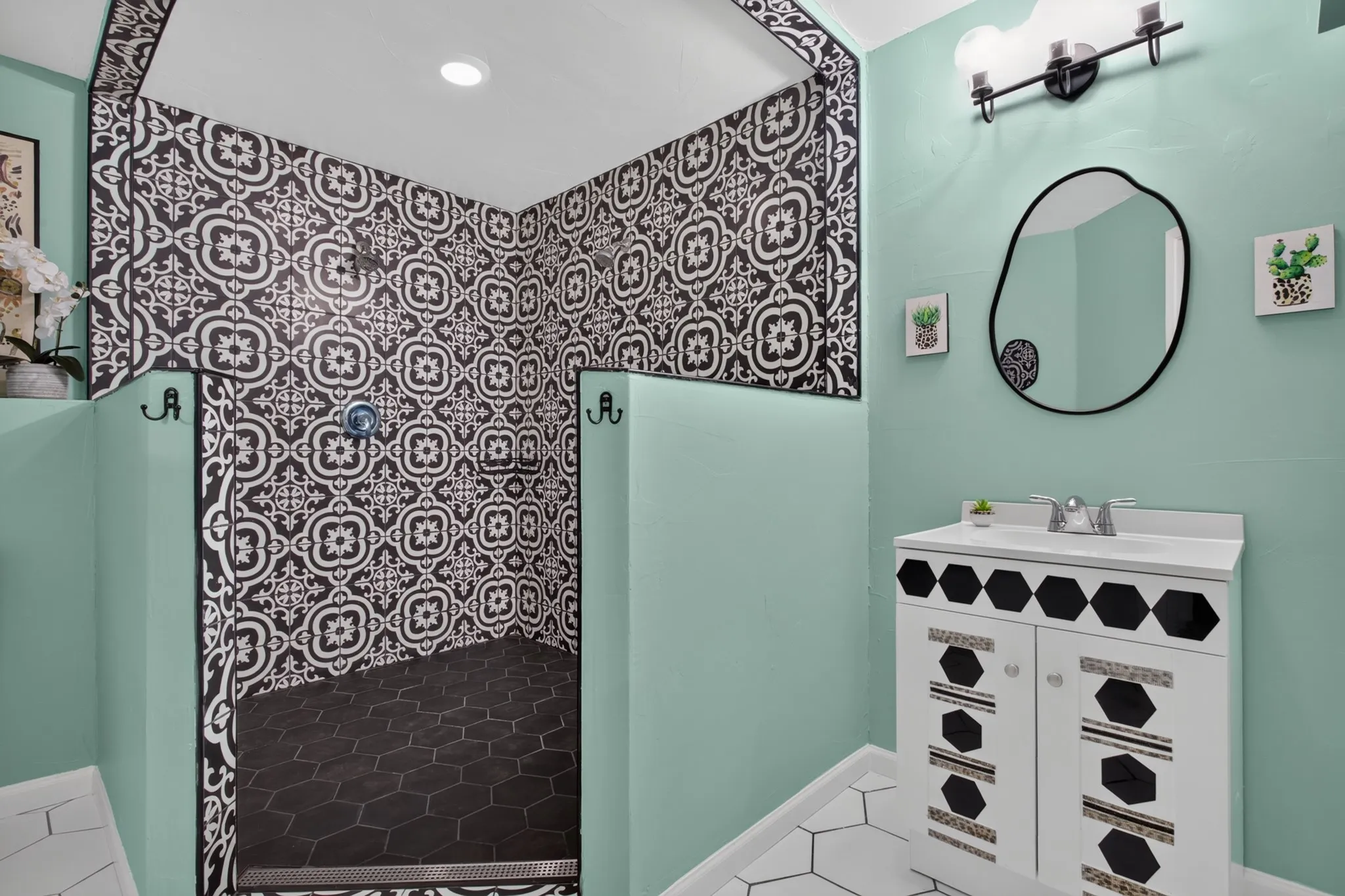 The main primary suite is a peaceful 20 x 22 retreat featuring picture windows, a custom walk-in closet with industrial pipe shelving and private access to its own covered patio. The beautifully remodeled ensuite bath features an oversized 11x8 seamless glass shower with designer tile.