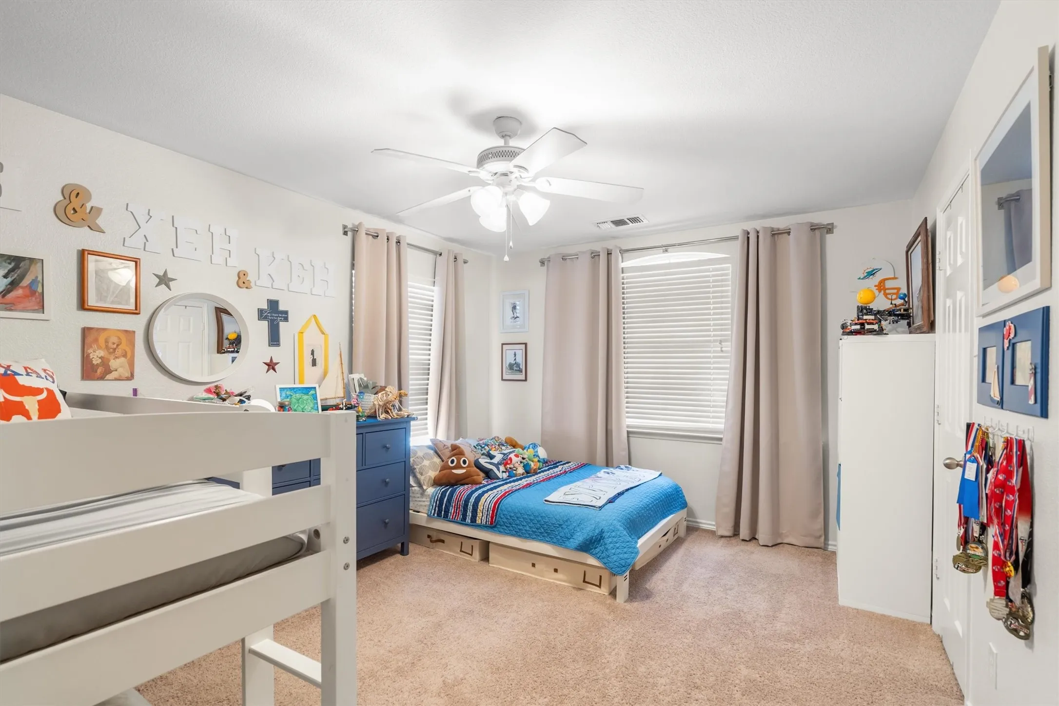 Carpeted flooring, ceiling fan with integrated lighting, natural light from windows with blinds, and white painted walls