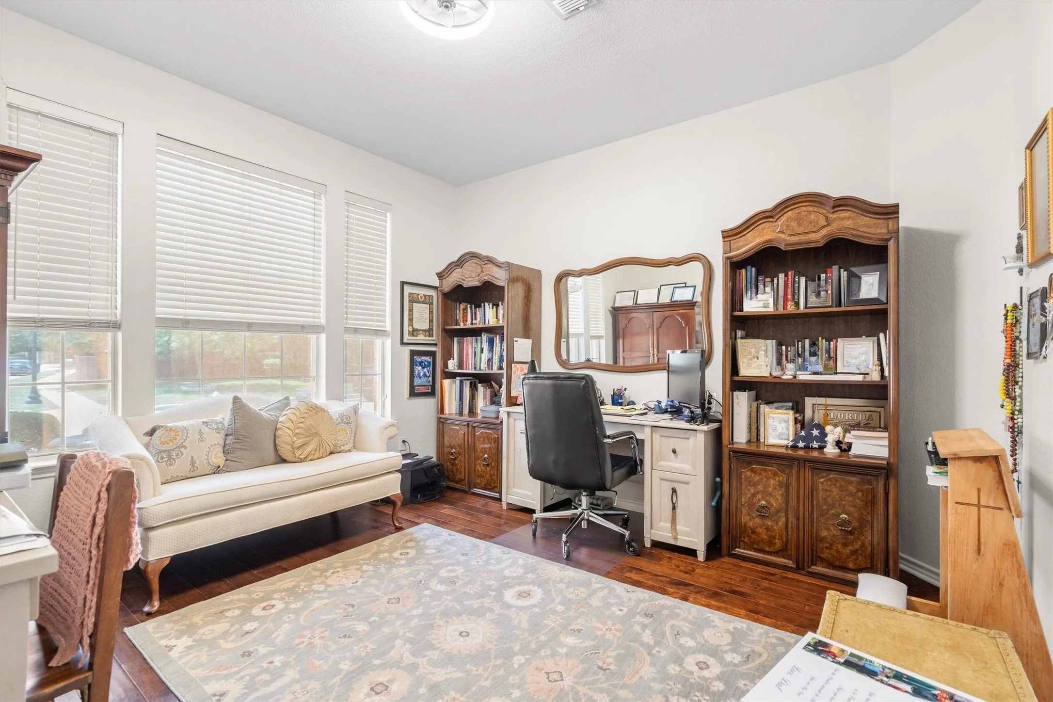 Recessed lighting, wood-finish flooring, and multiple windows with blinds