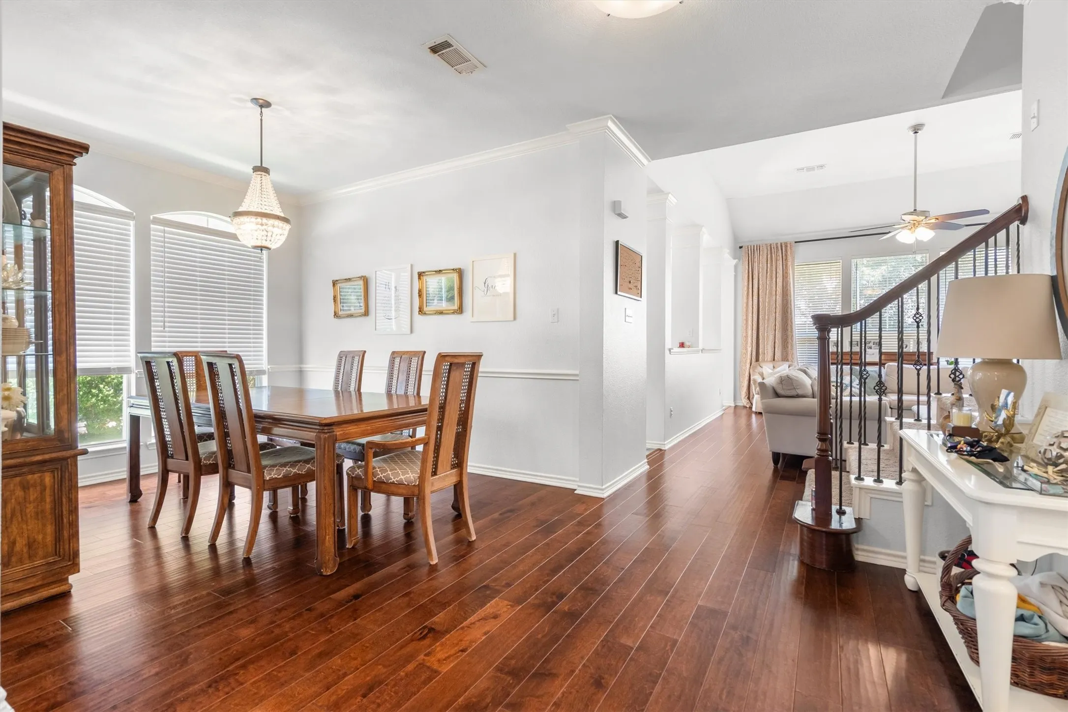 Wood-finish flooring throughout, with a decorative chandelier in the dining area