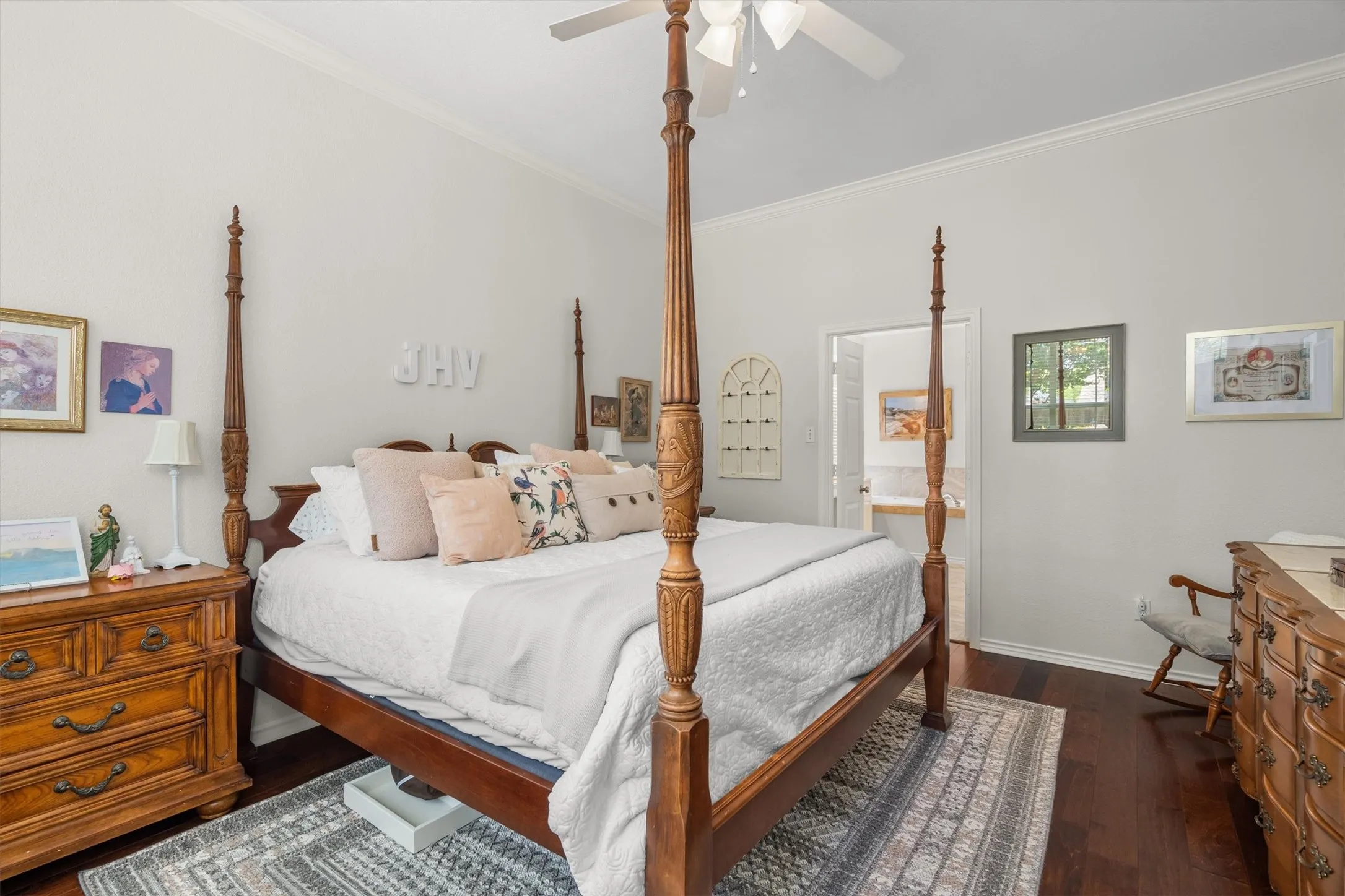 High ceilings, wood-finish flooring, crown molding, and a ceiling fan with integrated lighting