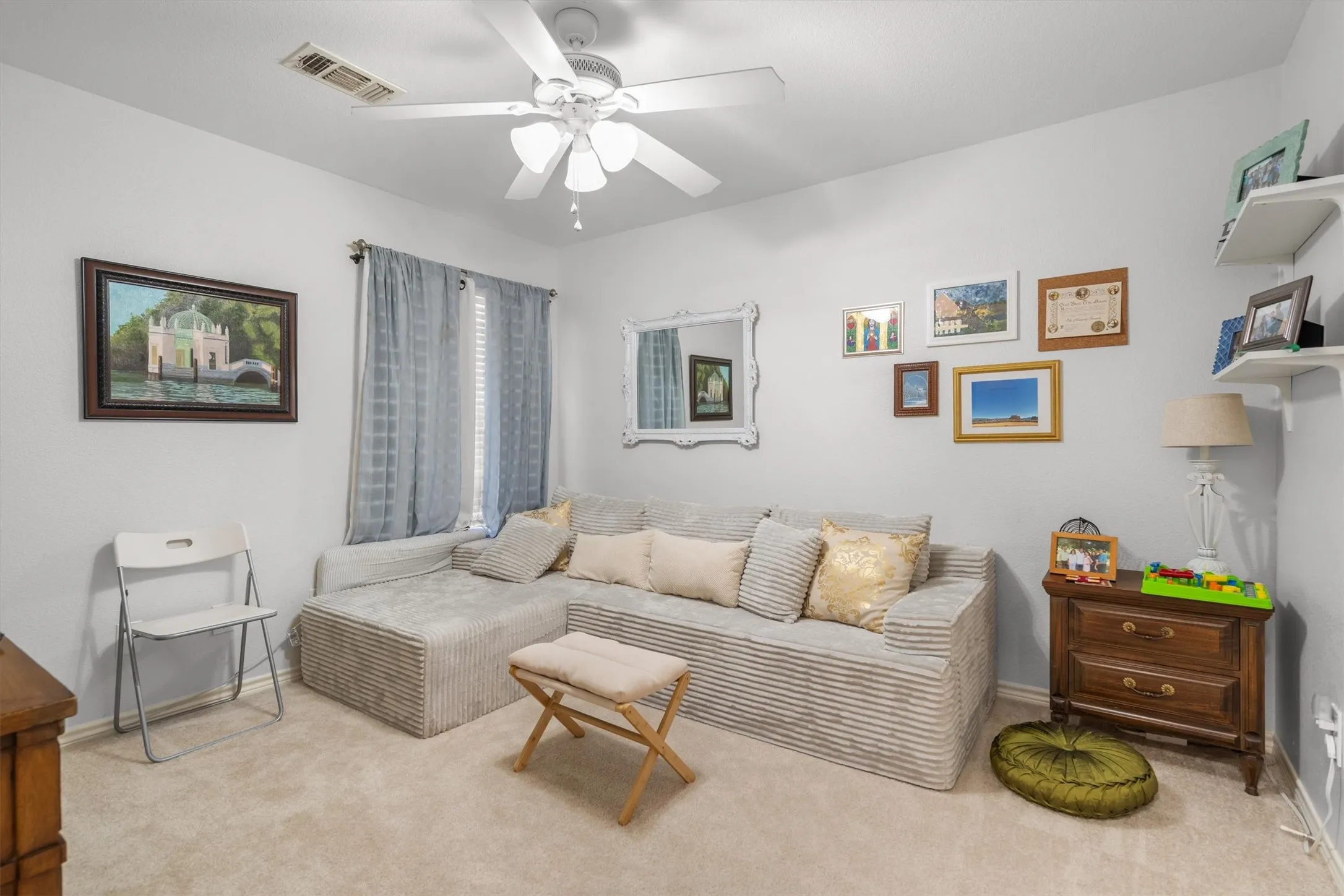 Recessed window with blinds, ceiling fan with light fixture, and wall-mounted shelving