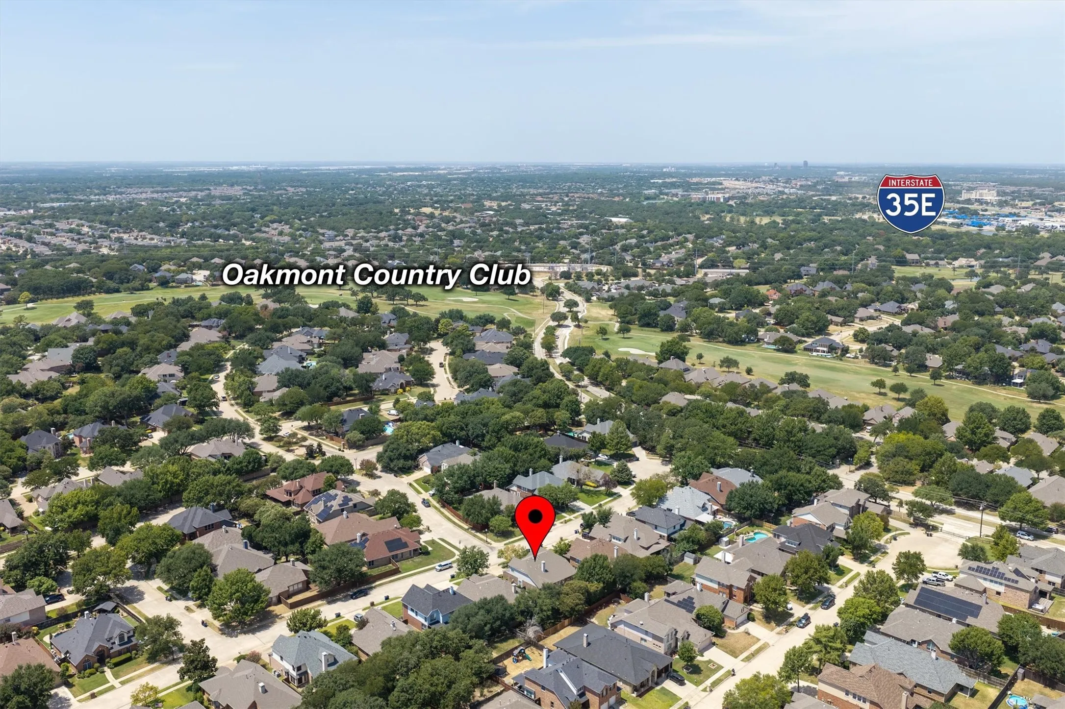 Aerial view showcasing this Oakmont Country Club residence situated on a generous lot within a tree-lined neighborhood