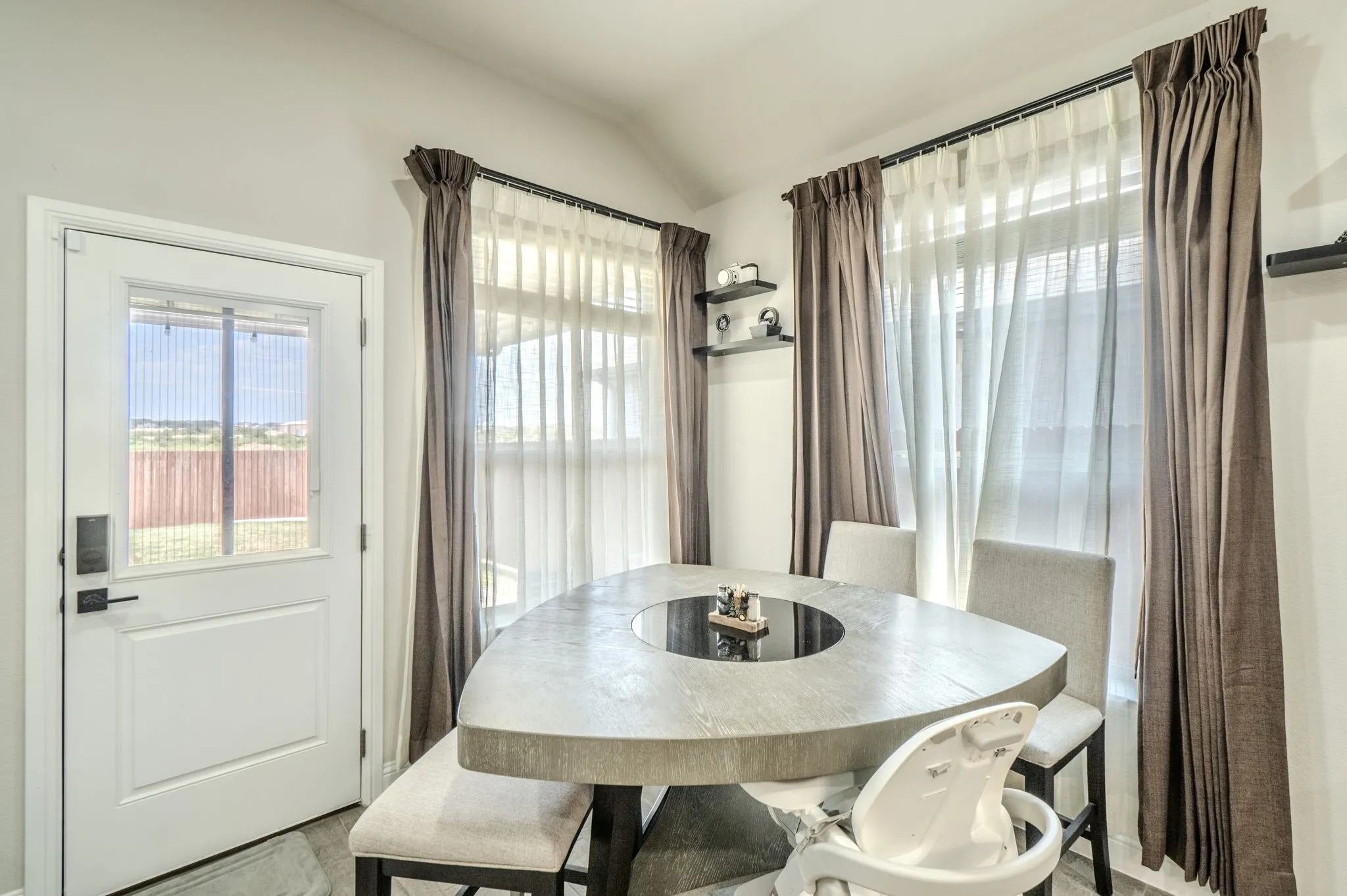 White paneled door with integrated window and black hardware