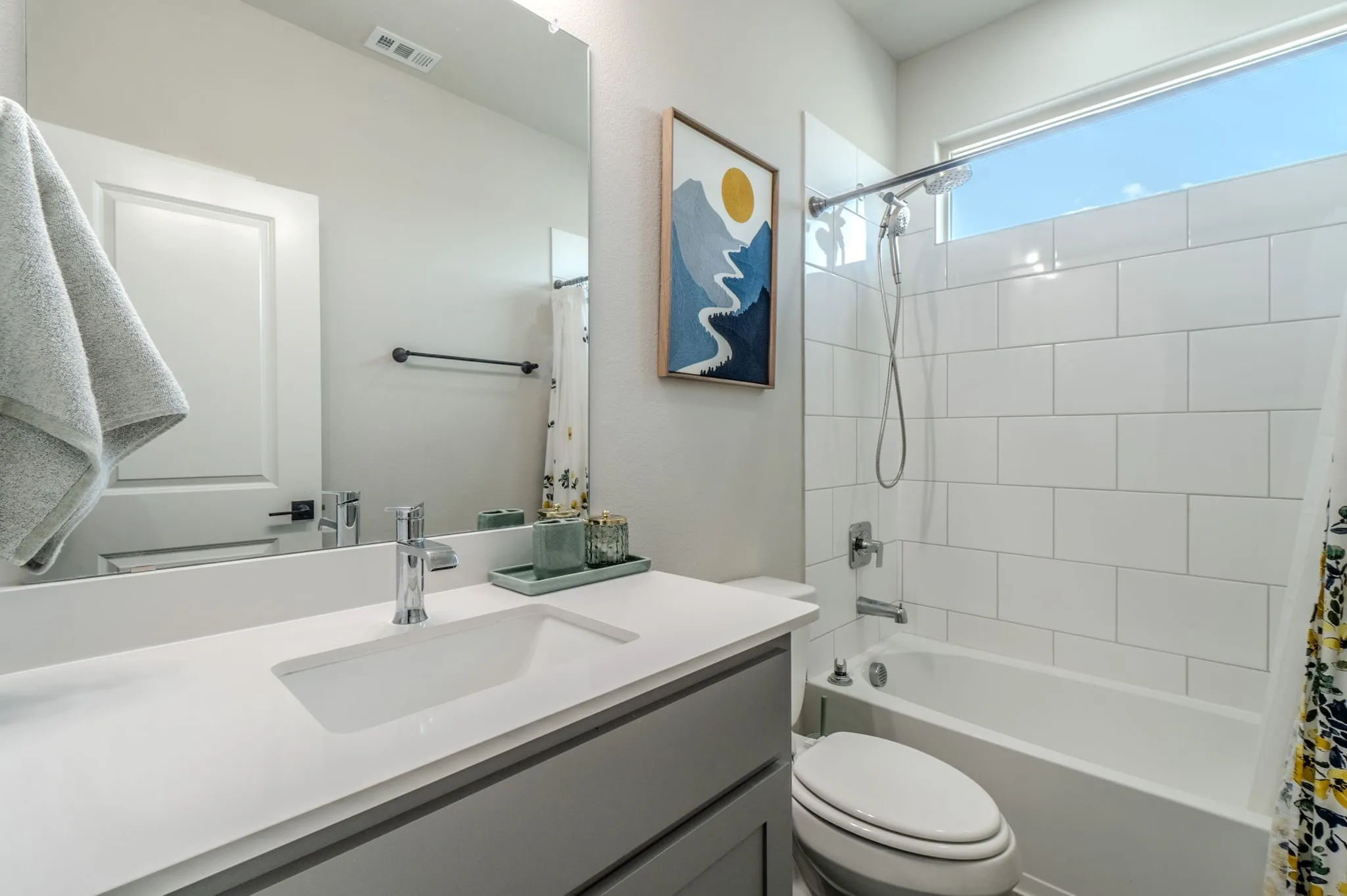 Integrated vanity with a rectangular basin, chrome faucet, and expansive mirror
