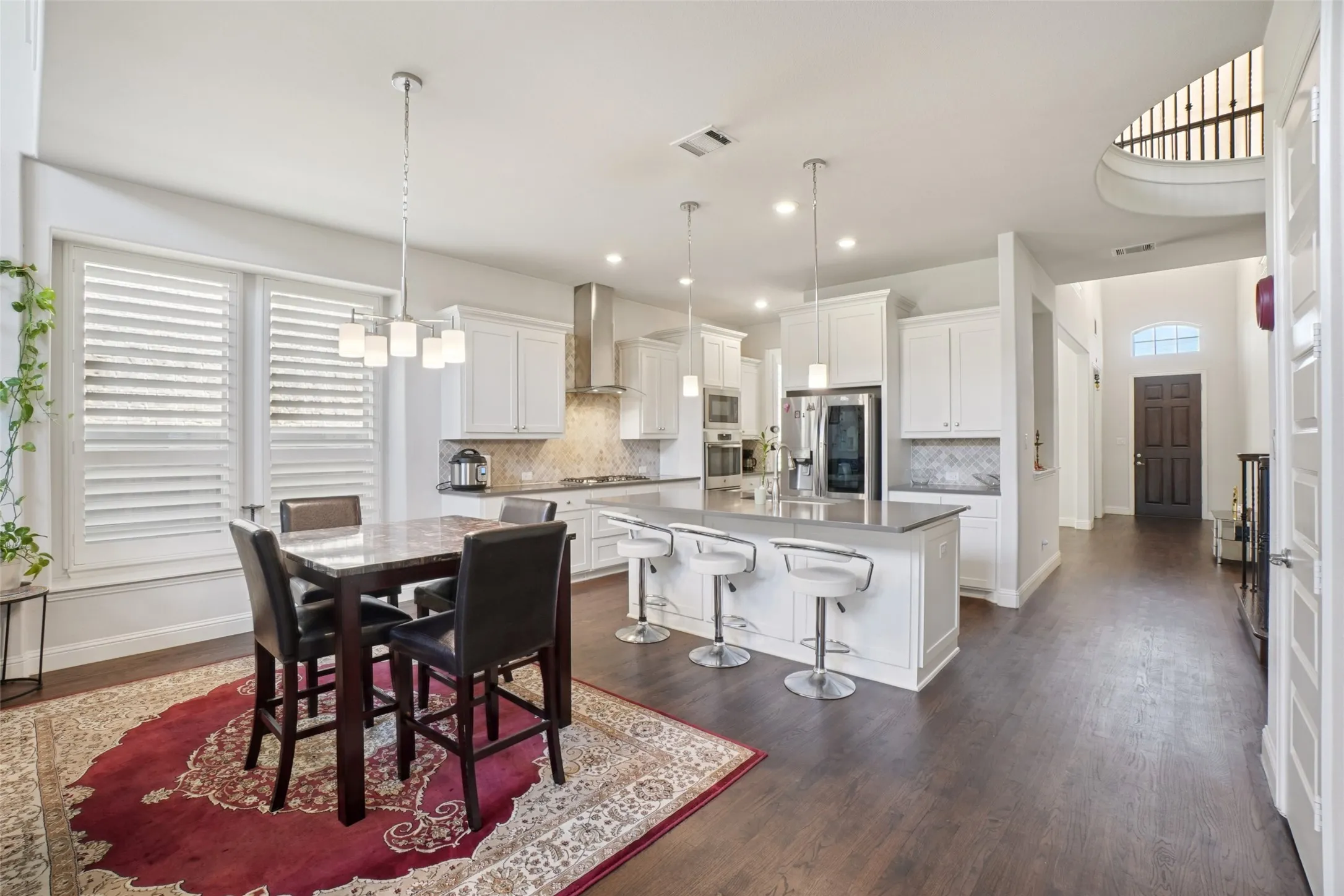 Dining space featuring dark wood-style flooring and recessed lighting