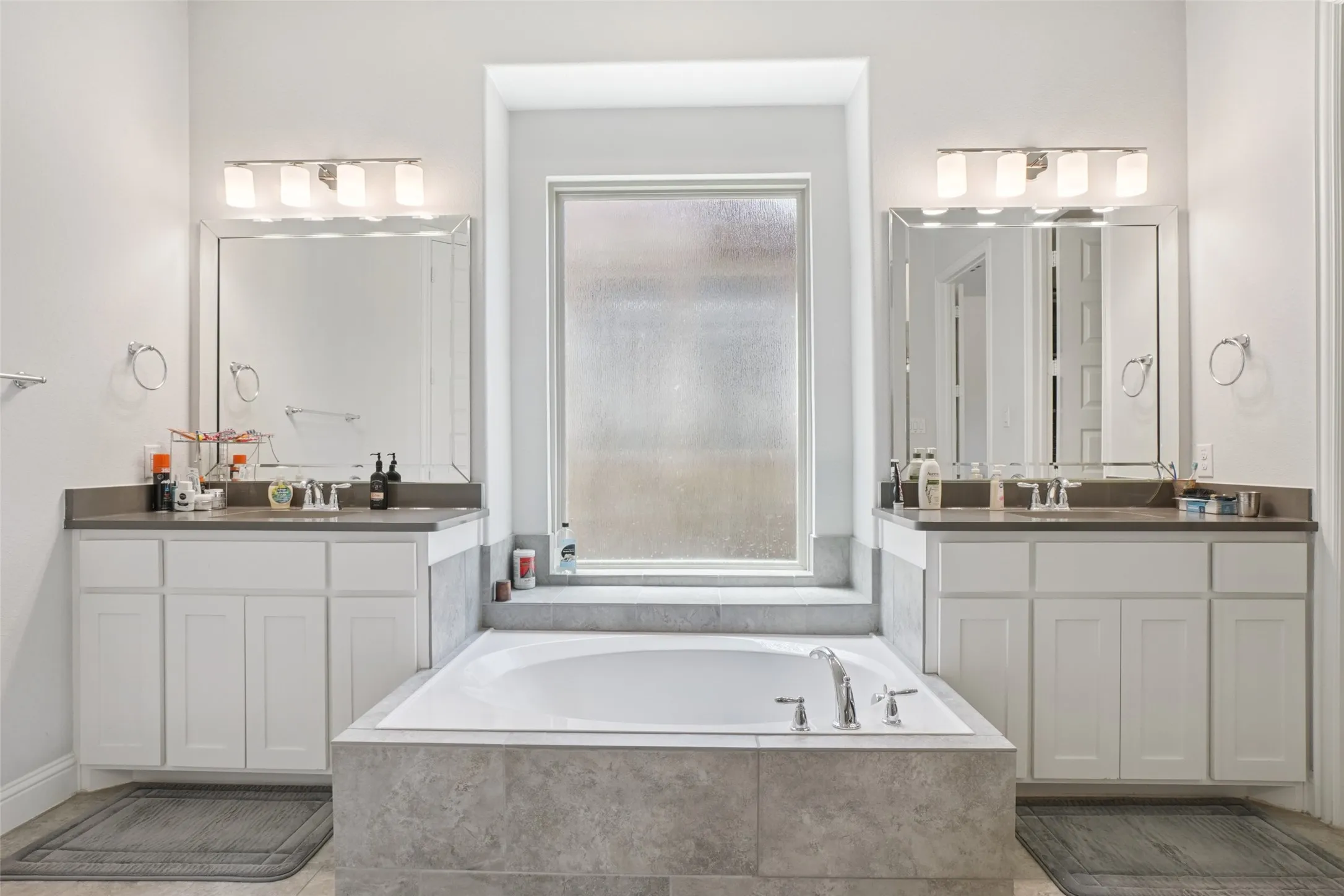 Bathroom with two vanities and a garden tub