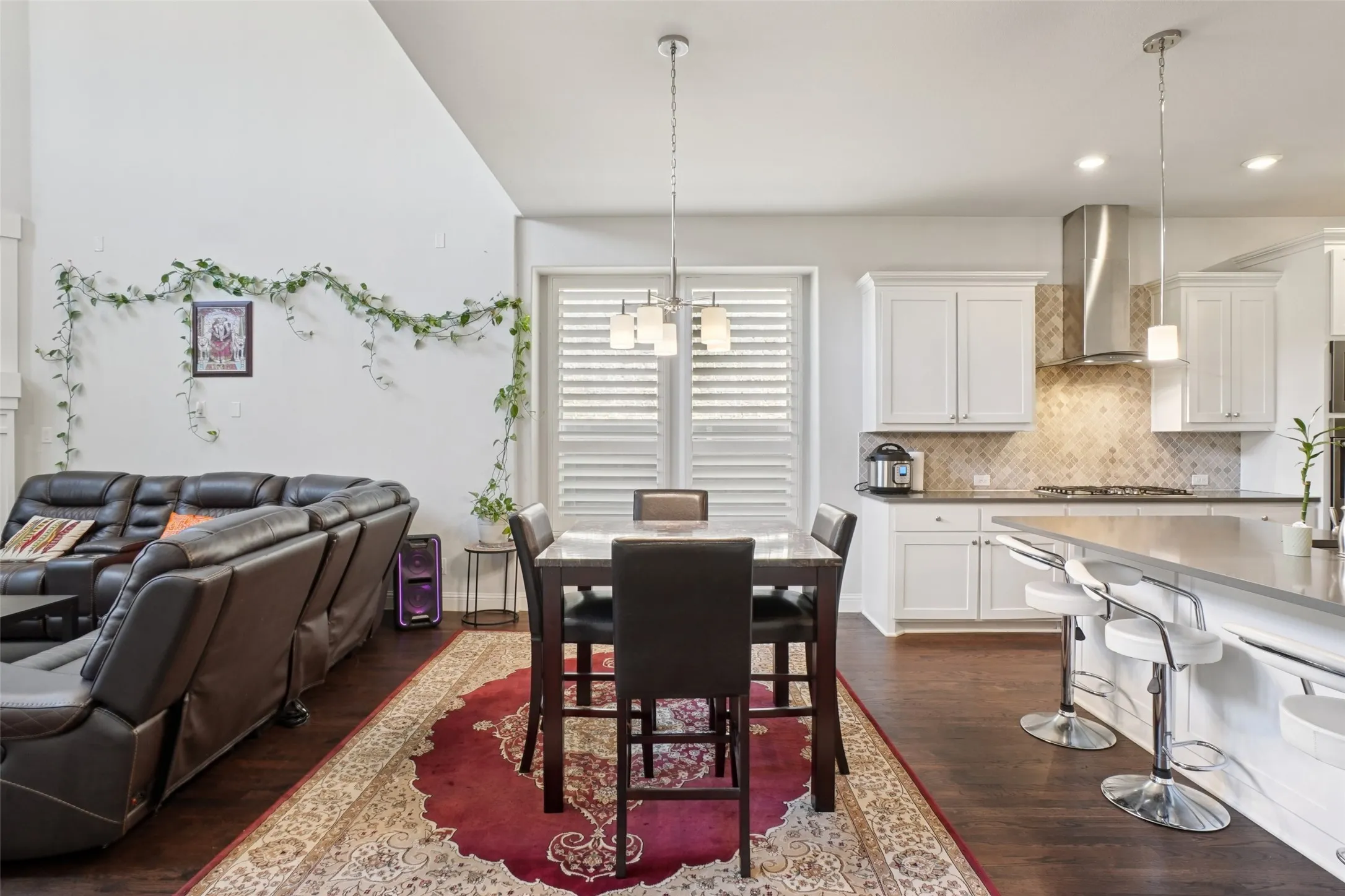 Dining room with dark wood finished floors, recessed lighting, and a chandelier